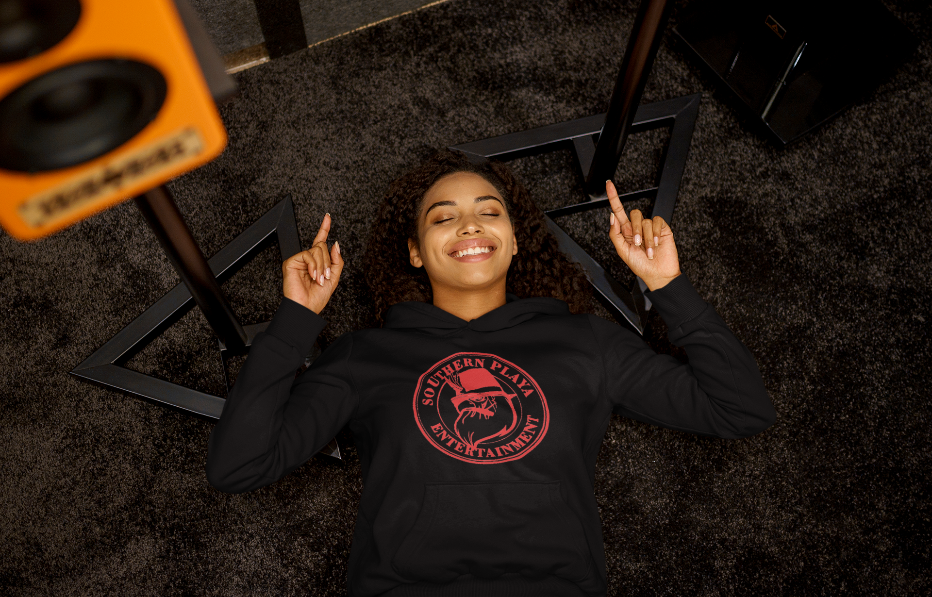 pullover-hoodie-mockup-of-a-woman-listening-to-a-happy-song-while-lying-on-the-floor-m23291-r-el2(1).png