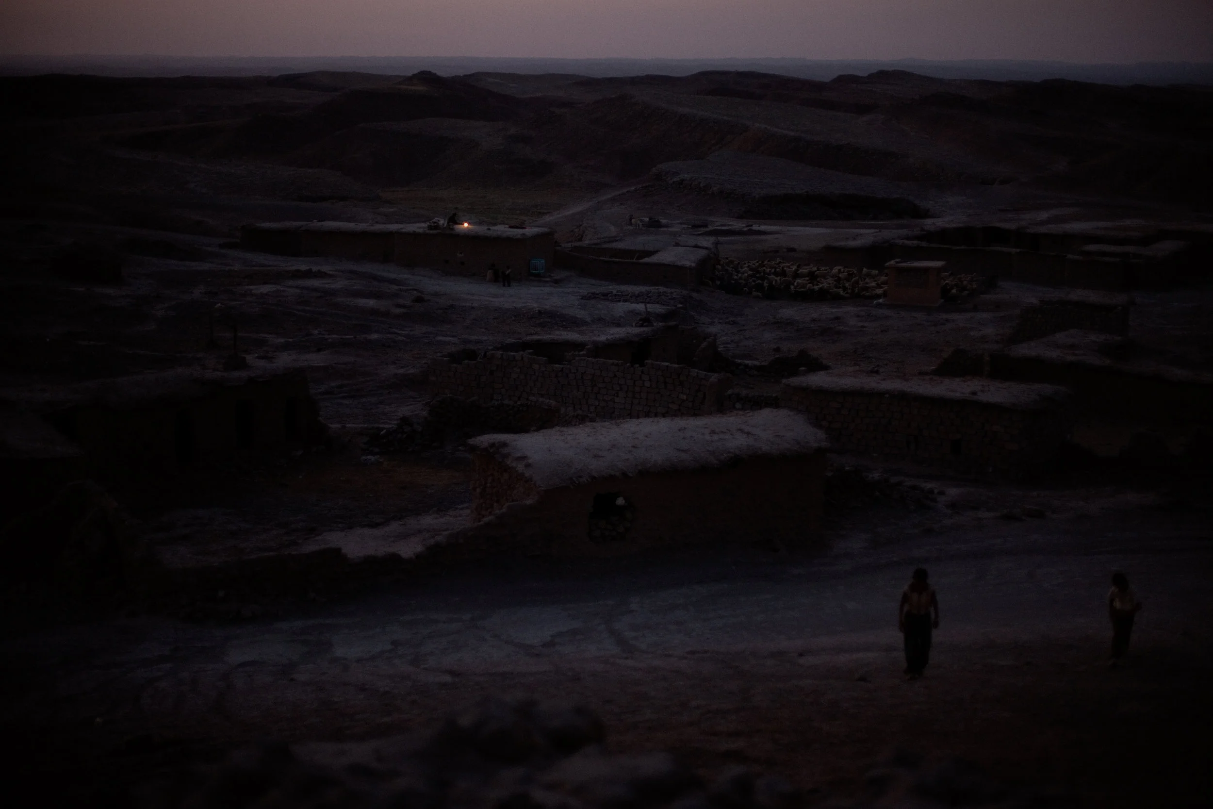 A lantern is lit on the rooftop of one of the few remaining occupied houses in Binika, Kifree District, Kurdistan, Iraq on July 10, 2010. Binika was once a thriving community with over 150 families, electricity, schools, and a clinic, but it was never completely rebuilt after Saddam Hussein's 1988 genocide against the Kurds. Few people returned to the village, and now, after years of conflict, economic instability, and sanctions on the region, only a handful of families remain.