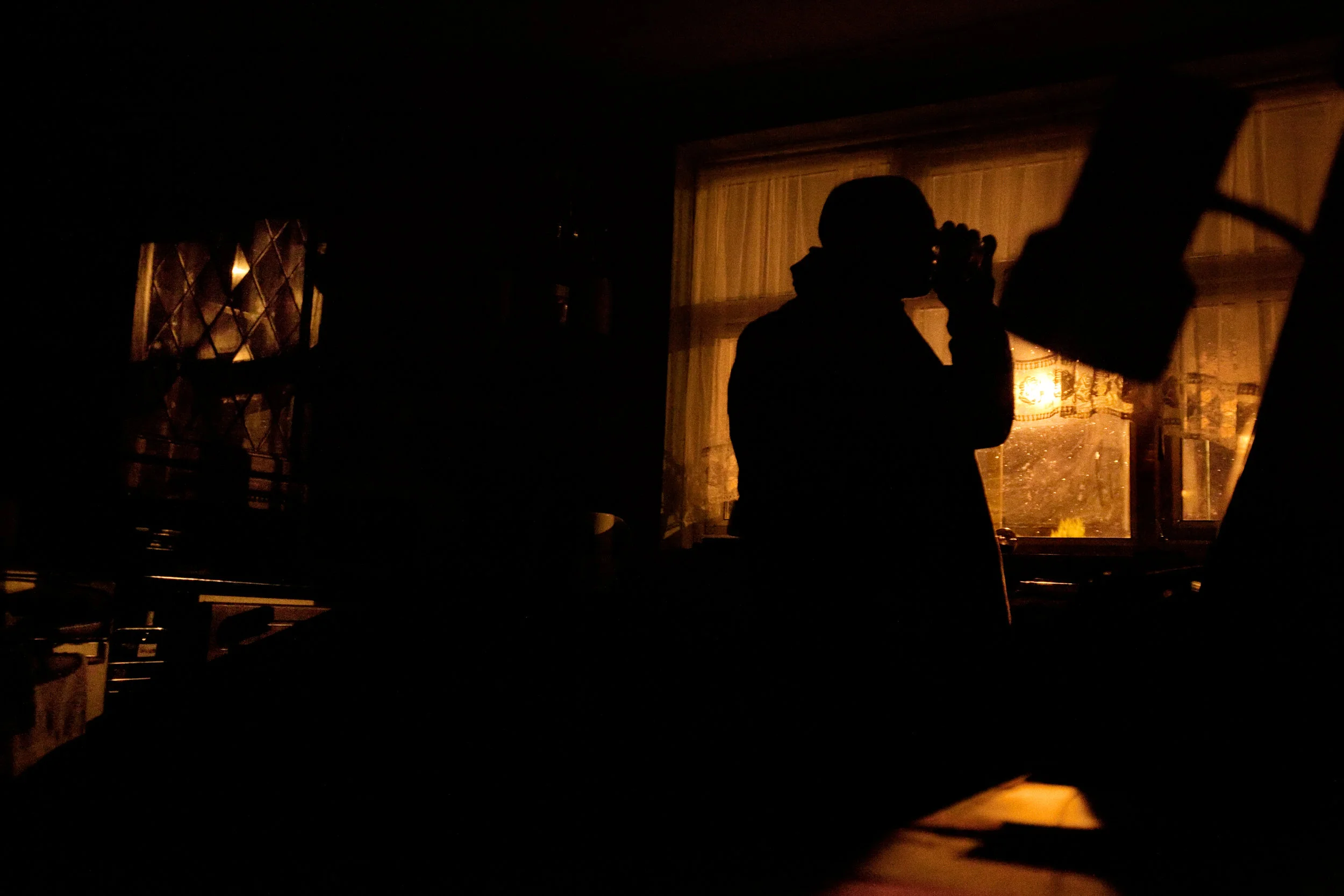 Richard Latham has a late-night drink in his home in Solihull, England, February 19, 2012. When Richard and his wife separated four years ago, he was left with a £400 energy bill that he is unable to pay off. He has not used heat in his home since then, and very rarely turns on light or electrical appliances, for fear of increasing his debt. "I'm a bit paranoid about power," he says.