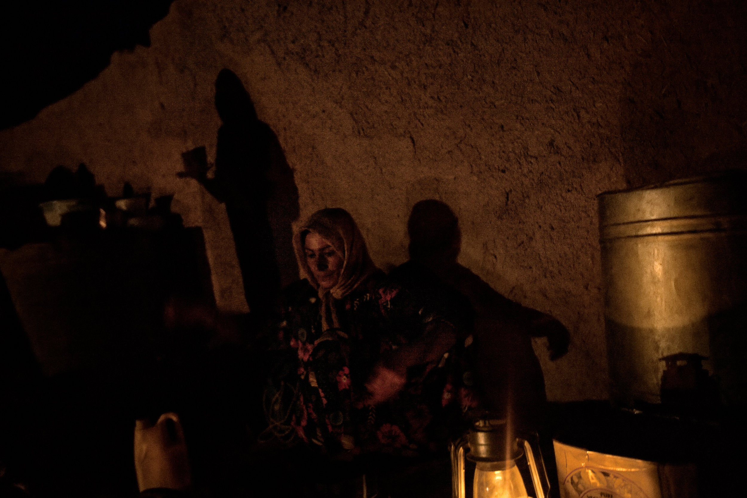  Kharaman Ibrahim Mohammed washes dishes by the light of a lantern in Showara, Kifree District, Kurdistan, Iraq on July 3, 2010. 