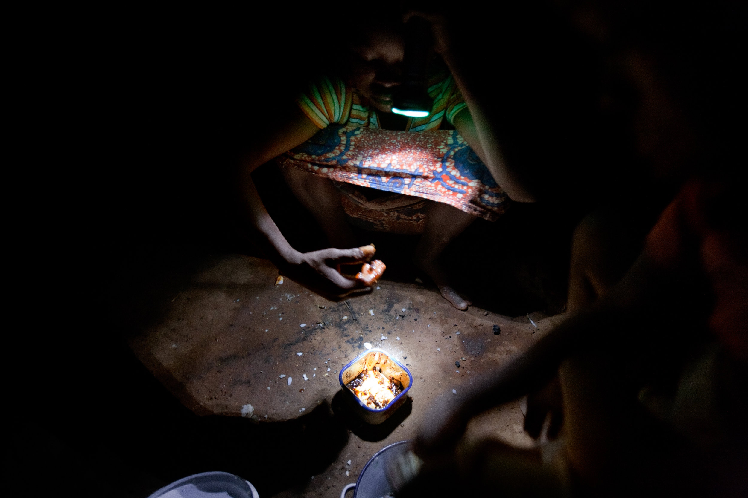  A young girl eats dinner in her home in Voggu, Northern Region, Ghana, on Nov. 17, 2009. 