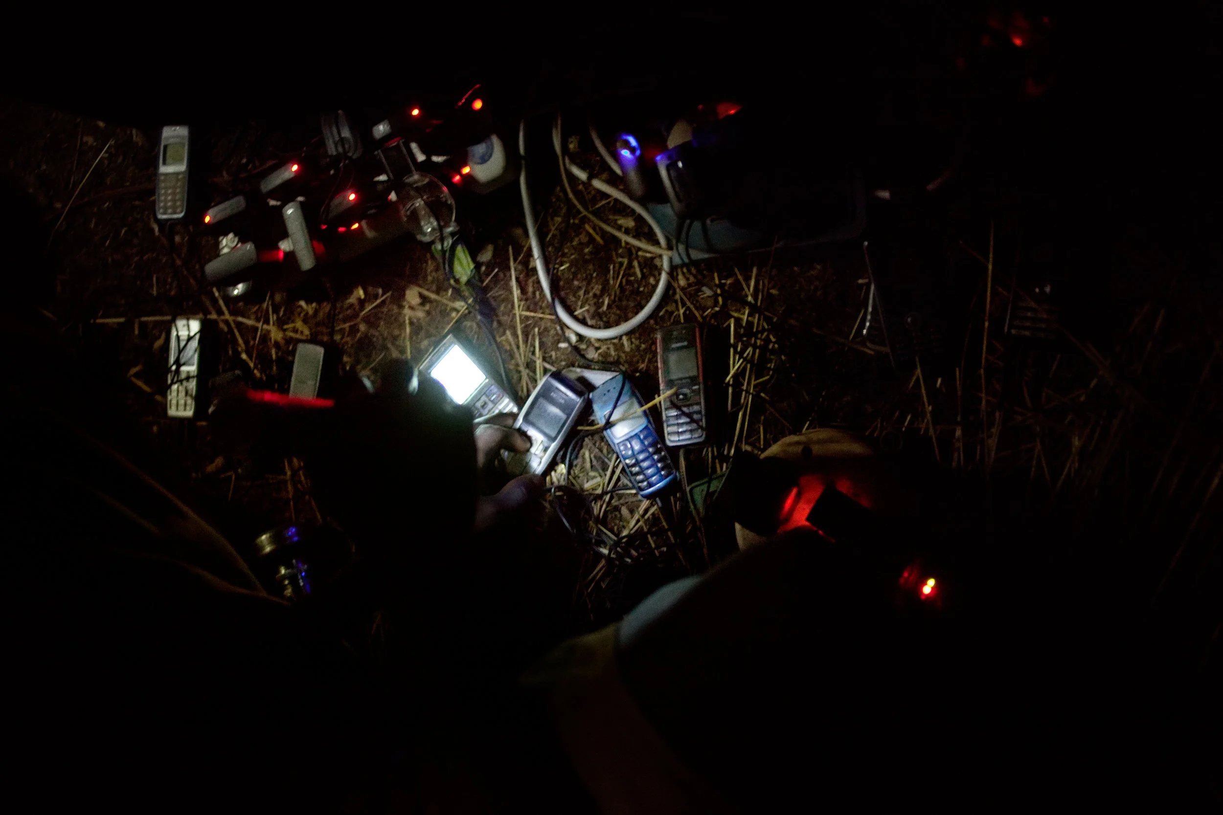 Mobile phones charge off of a generator in Voggu, Northern Region, Ghana on Feb. 14, 2010. The people of nearly every household in the village have at least one phone in their possession. The owner of the generator takes a small amount of money for each person to charge his or her phone, while simultaneously using the generator to show a film or power a stereo system.