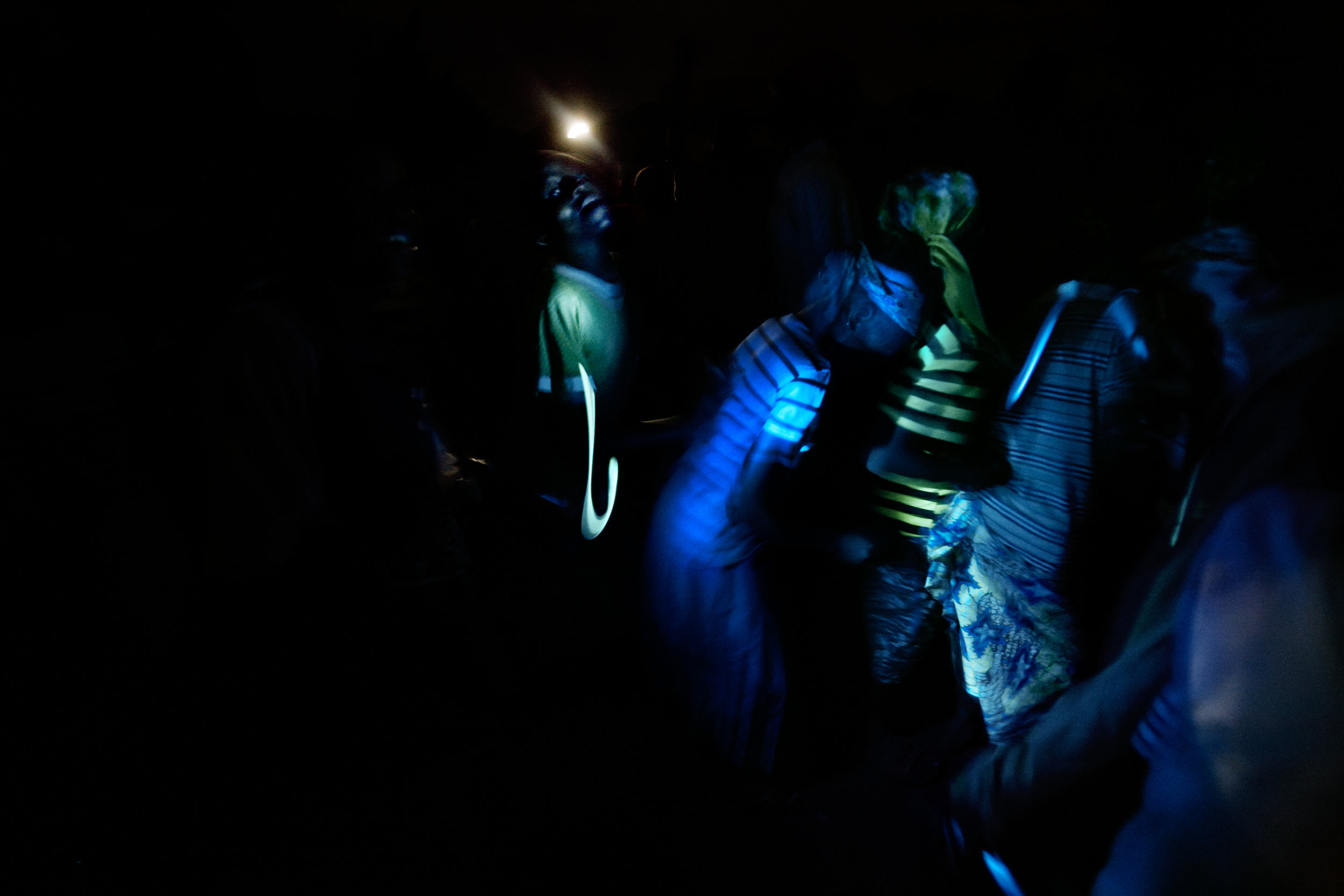  Children dance by flashlight outside of Wantugu, Northern Region, Ghana on June 30, 2007. 