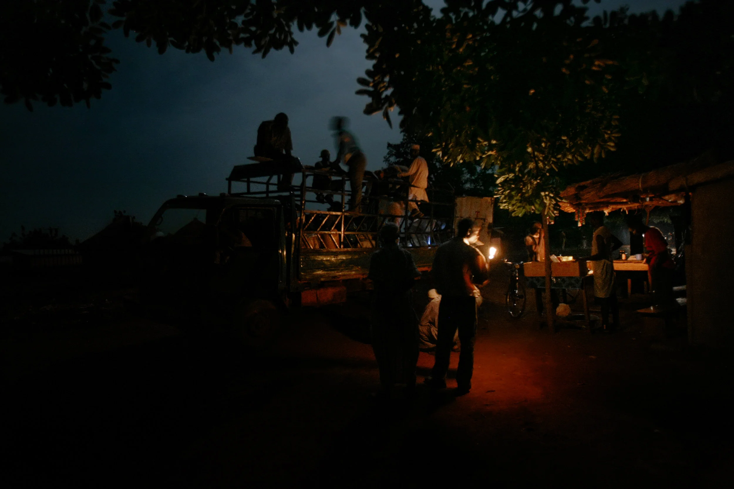 People board the last car of the night through Wantugu, Northern Region, Ghana on June 27, 2007.