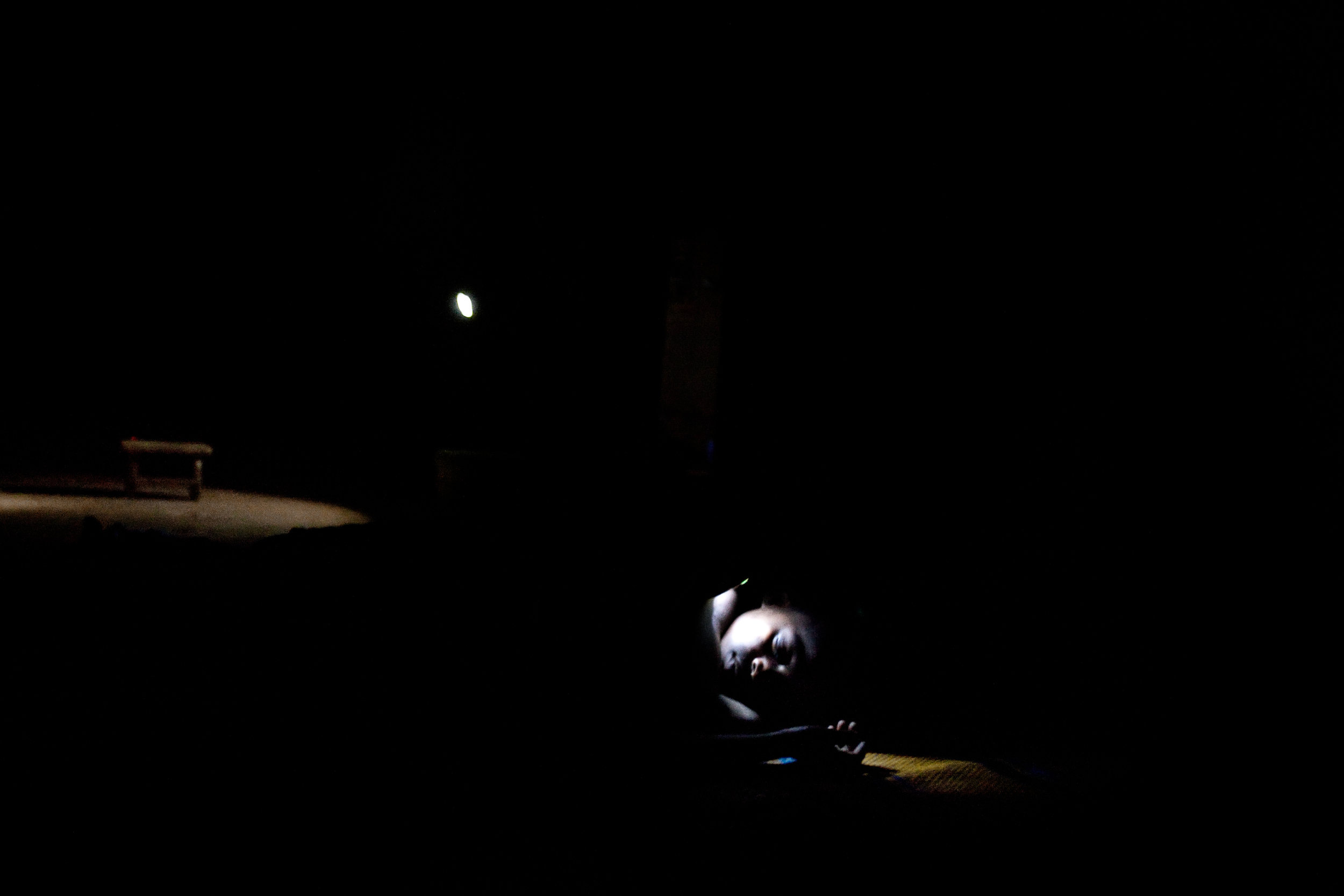  Zenabu Abubakari, a young girl, falls asleep in Voggu, Northern Region, Ghana on Feb. 15, 2010. 