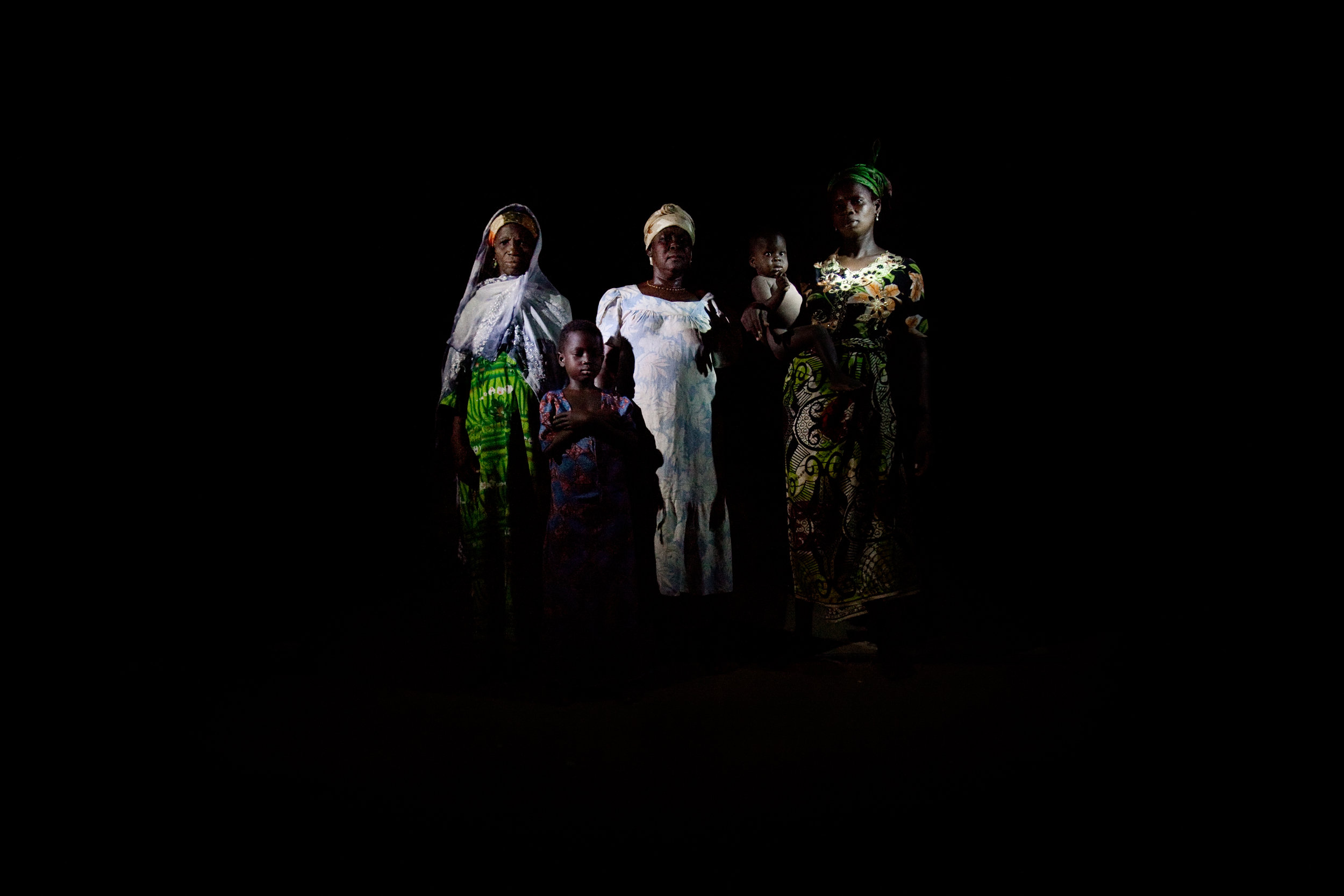  The women and children of the Abubakari household pose for a portrait lit with flashlights in Voggu, Northern Region, Ghana on Feb. 20, 2010. Women bear the heaviest burden of living without electricity, as they walk for miles to fetch firewood and 