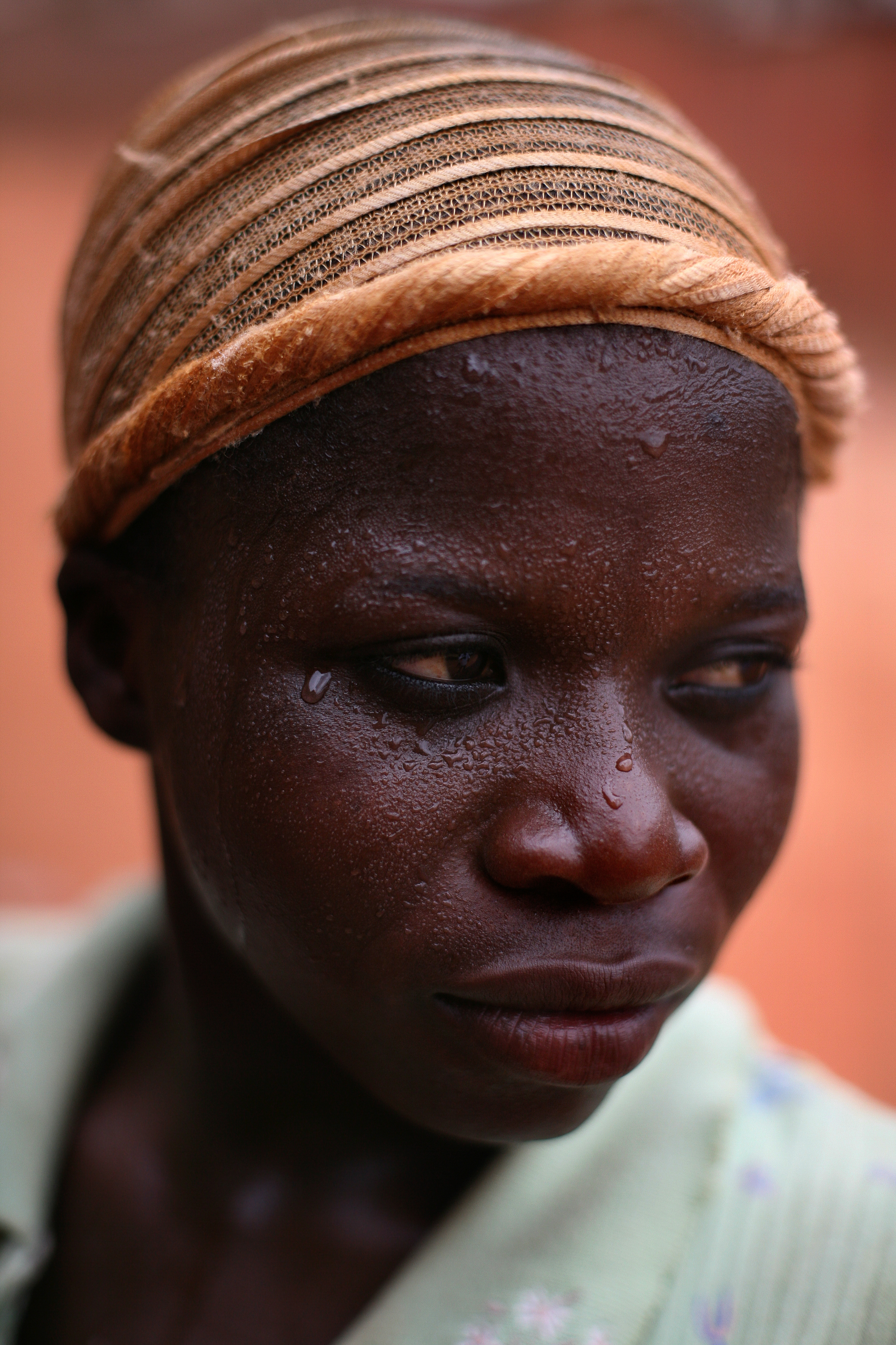  A Kayayo woman sweats after chasing a car with hopes that the passengers would pay her to carry their bags in Kumasi, Ghana on Feb. 26, 2010. The Kayayo are a class of thousands of women and girls from barren northern Ghana who travel to southern ci