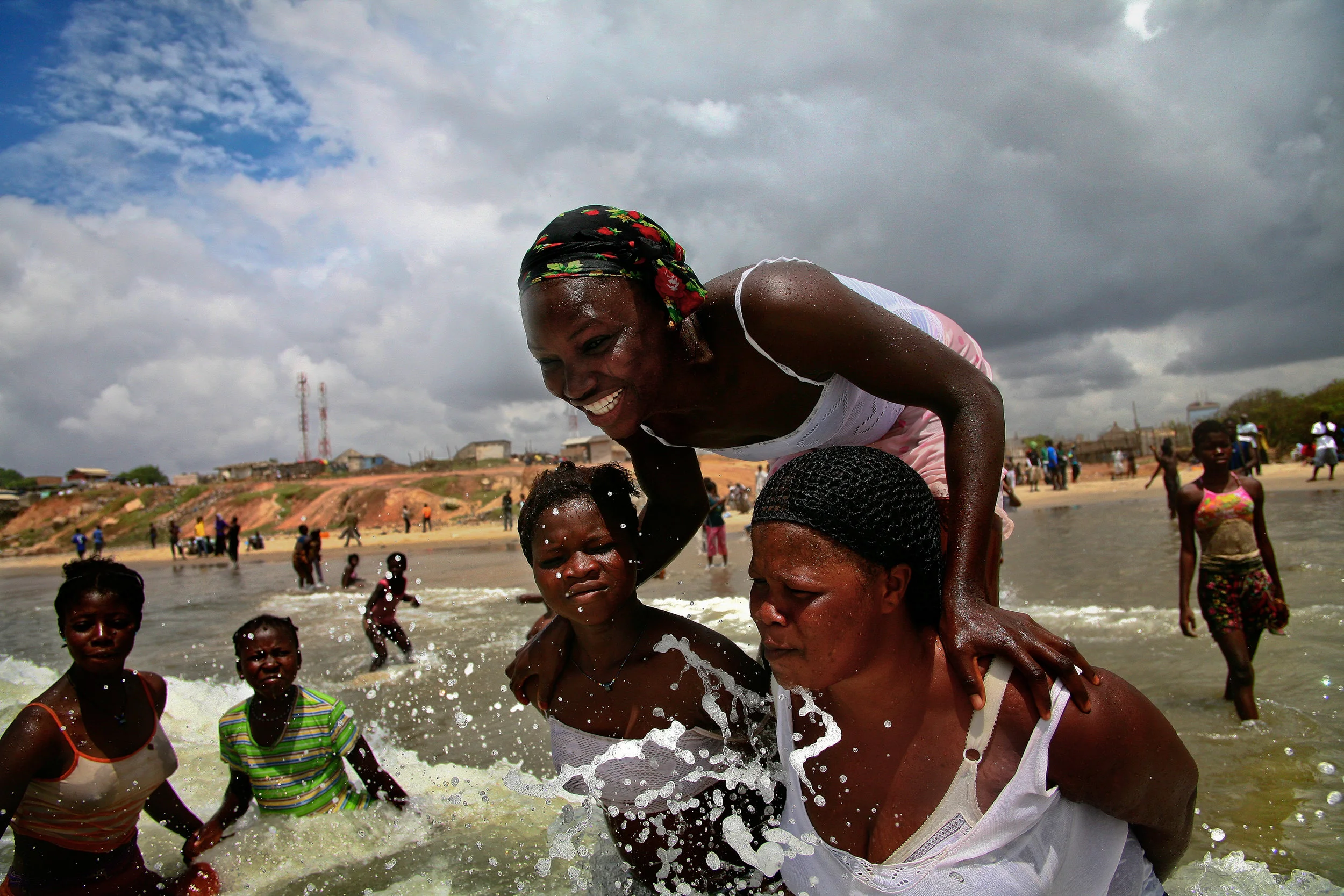 Fatima stands on the backs of other girls while playing at a beach in Accra, Ghana on Oct. 12, 2008. A Muslim girl from Ghana's north, she had never seen the ocean before coming to Accra a few months prior. "I like swimming," she says, "but I don't like how boys and girls swim together here."