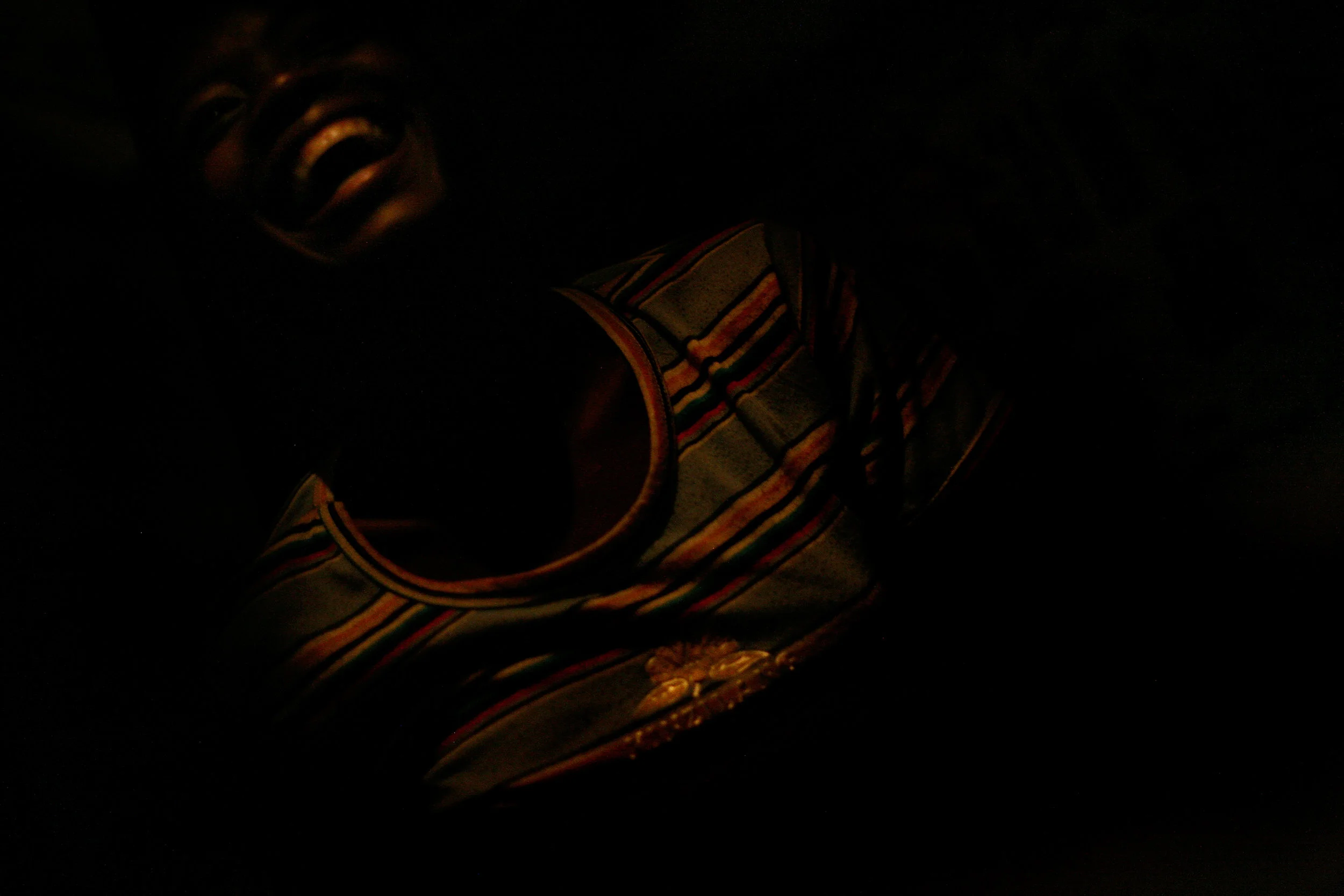 A girl laughs in the room she shares with 14 other girls in a slum in Accra, Ghana, Feb. 9, 2009.