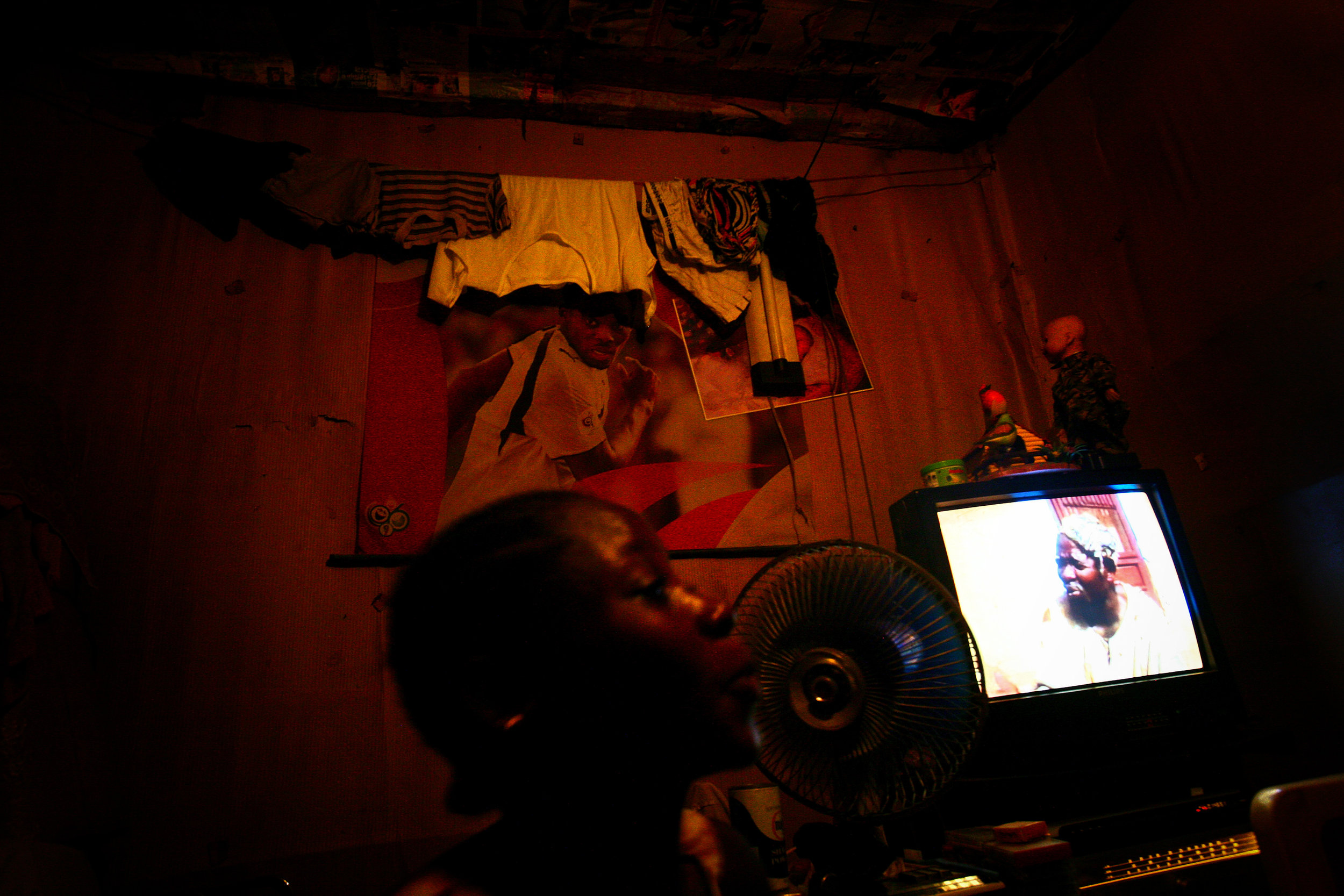  A young woman watches a film in her room in Accra, Greater Accra Region, Ghana on Oct. 5, 2008. 