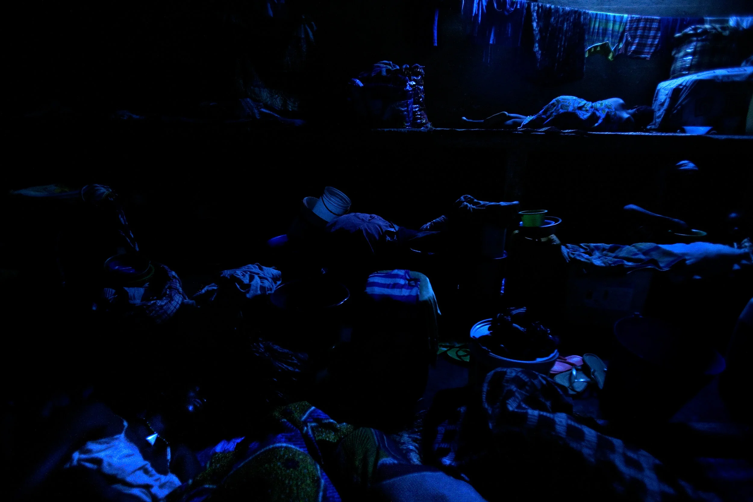 Kayayo girls and women sleep on the floors and counter-tops in a former warehouse where several hundred of them live in Kumasi, Ghana on Feb. 26, 2009.