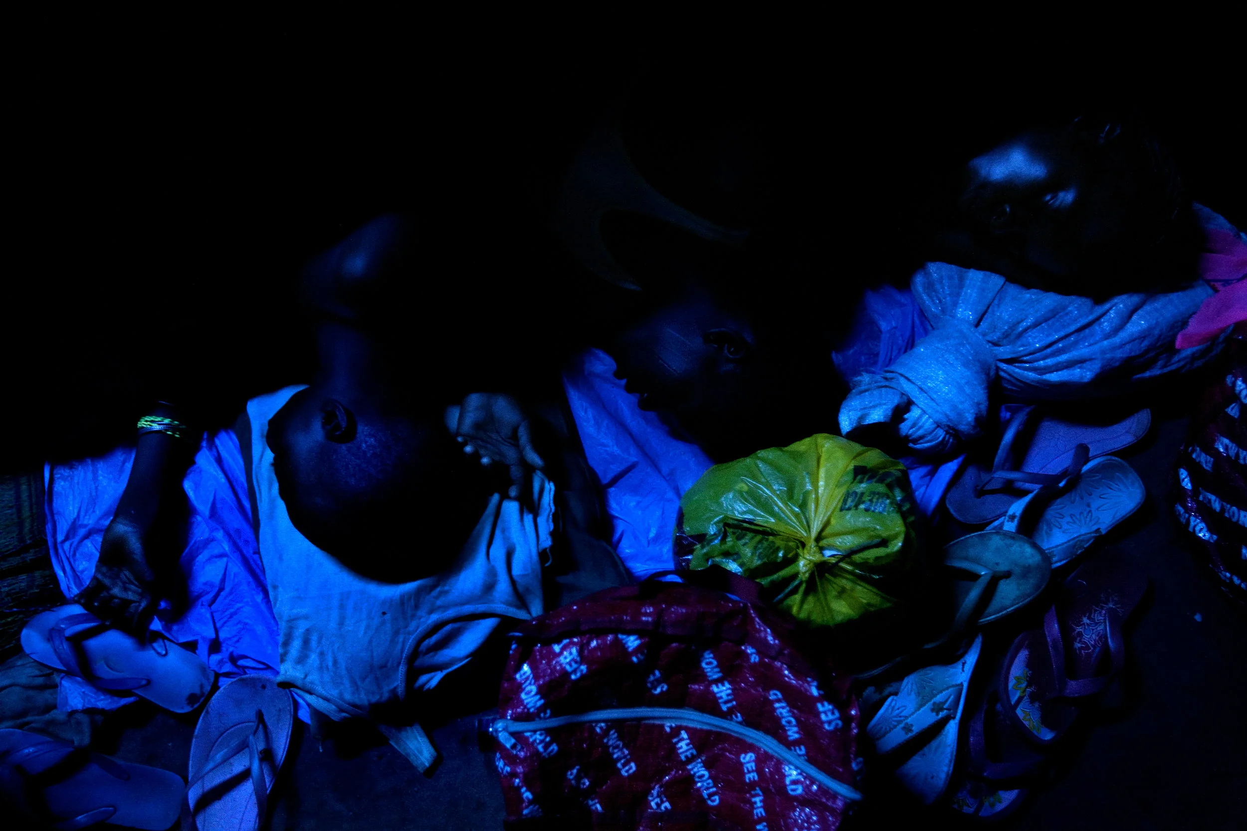 Kayayo girls huddle together while sleeping on the floor of a former warehouse where several hundred of them live in Kumasi, Ghana on Feb. 26, 2009.
