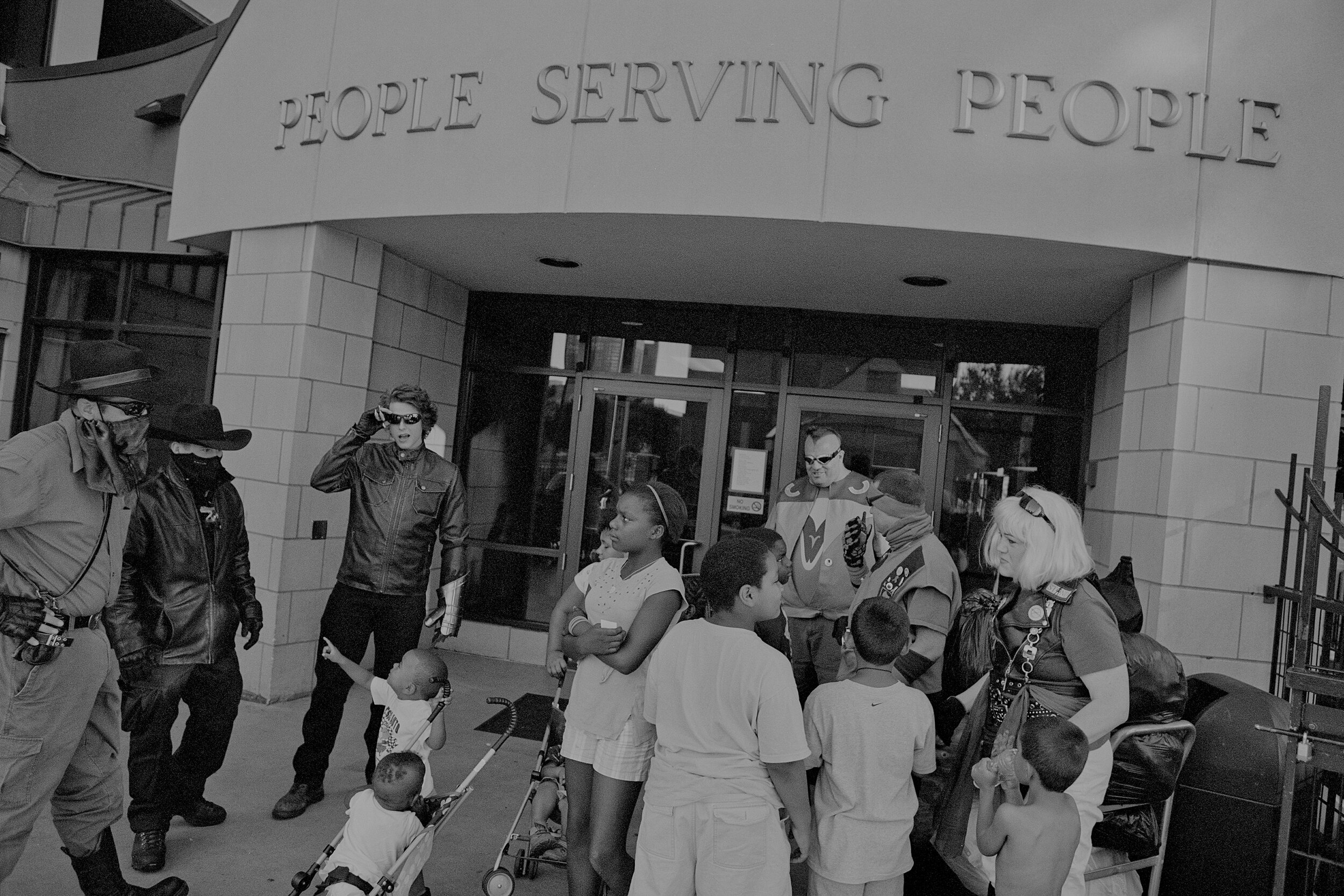  Superheroes meet with children outside of a shelter in Minneapolis, MN on Aug. 5, 2012. Superheroes, from left: Geist, Caligrio, Gauntlet, Razorhawk, Blue, and Misery White. 