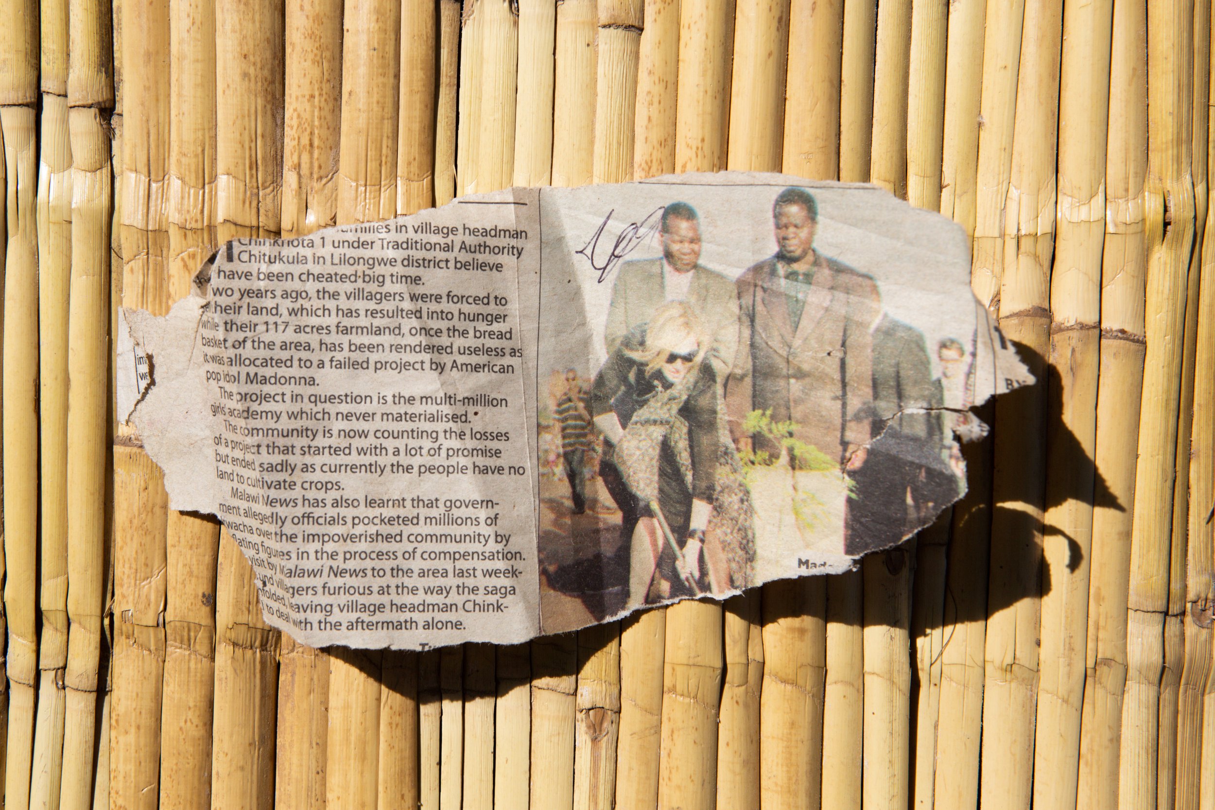  Newspaper clipping kept by Chief Binson Kalenga of Chinkhota 1, Malawi, showing Chief Kalenga, right, and Madonna as she plants a tree. Chinkhota 1, Lilongwe District, Malawi. Original photograph 2009, copy photograph June 6, 2015. 