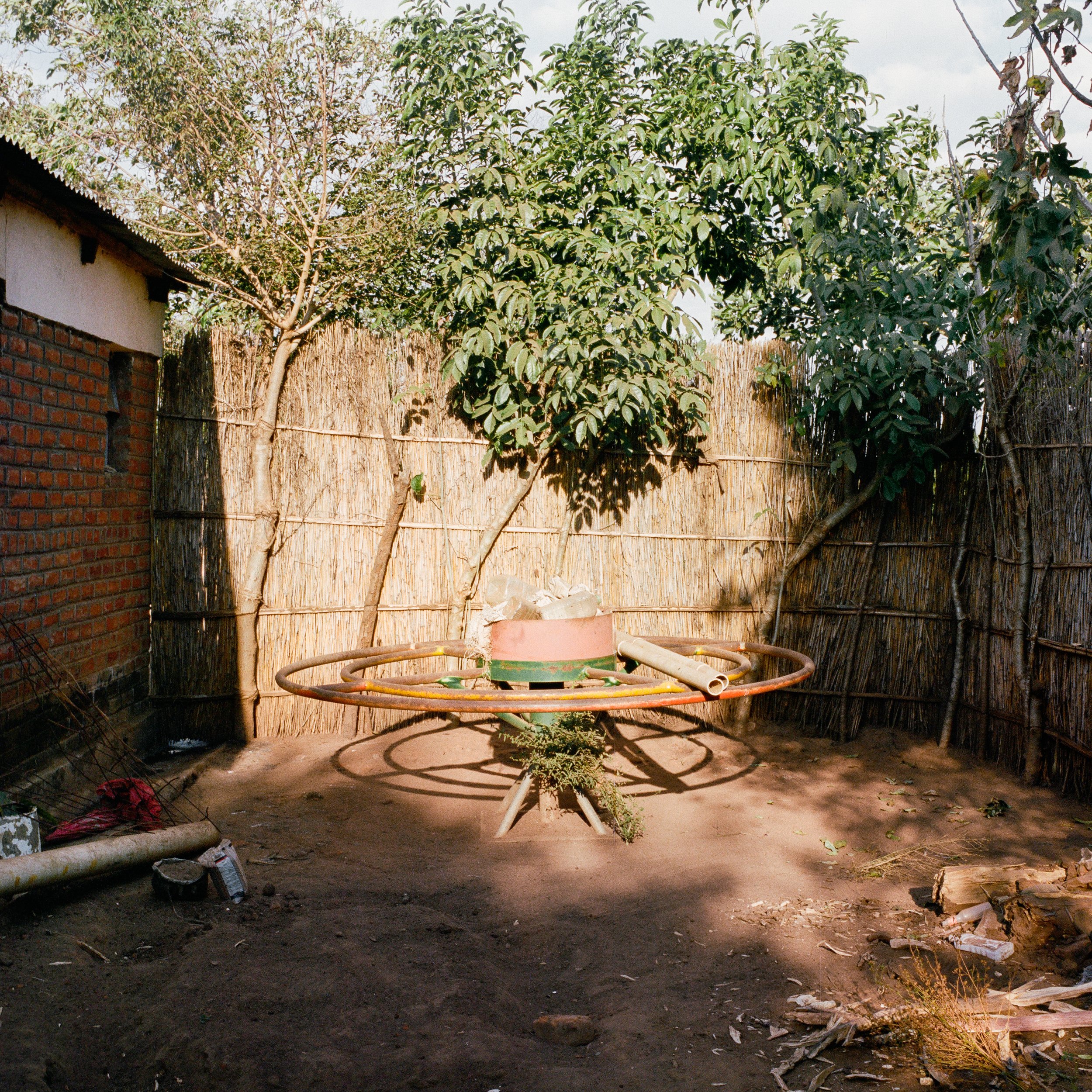  Broken PlayPump in a family compound. Chingagwe, Balaka District, Malawi. Installed 2012, removed 2013, photographed June 13, 2015. This PlayPump functioned for a couple months and then broke, and the community was able to replace it with a handpump