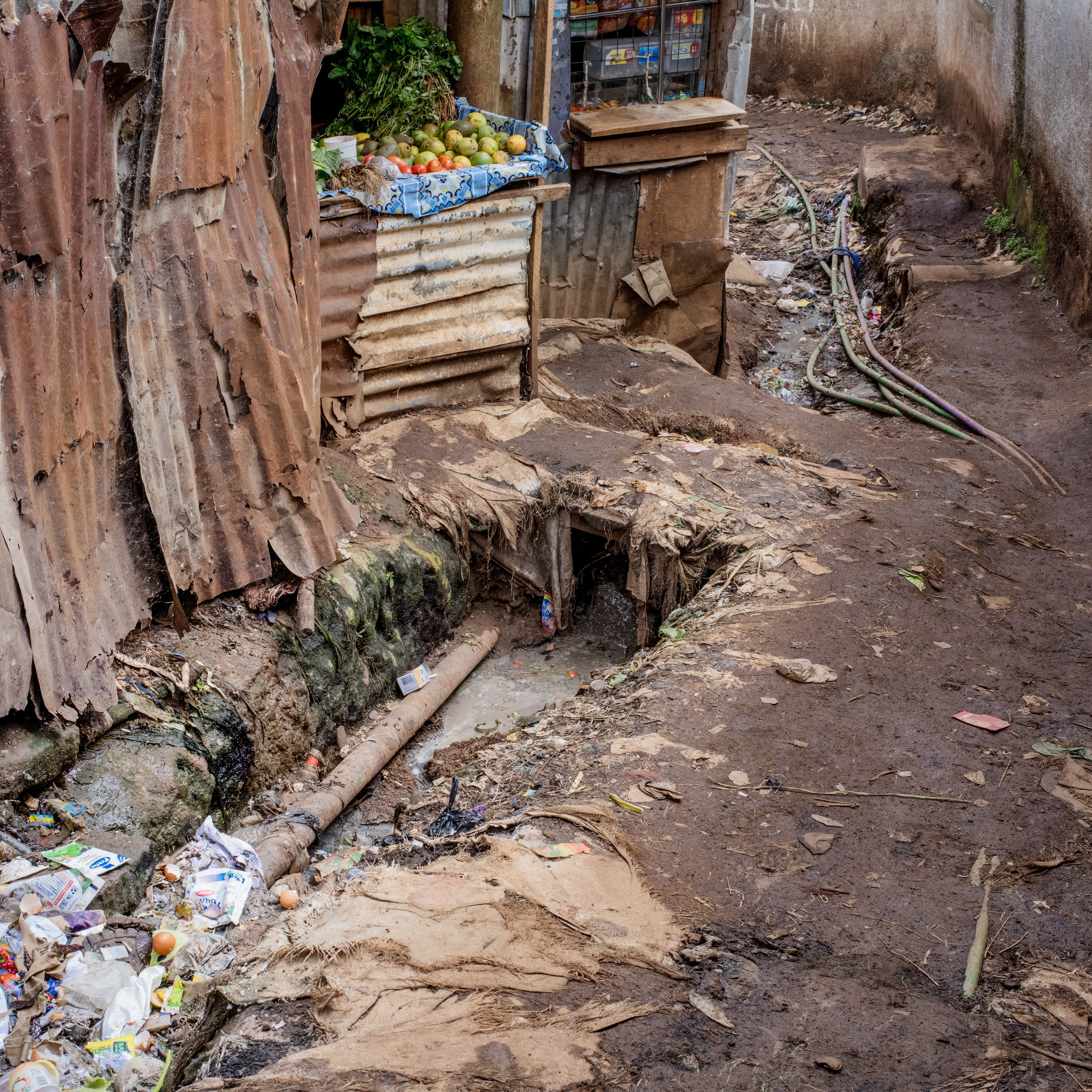  Water infrastructure. Kibera, Nairobi, Nairobi County, Kenya. Photographed May 9, 2018. The brown pipe in the bottom left is part of the official infrastructure provided by&nbsp; Nairobi City Water and Sewerage Company, funded by World Bank, and is 