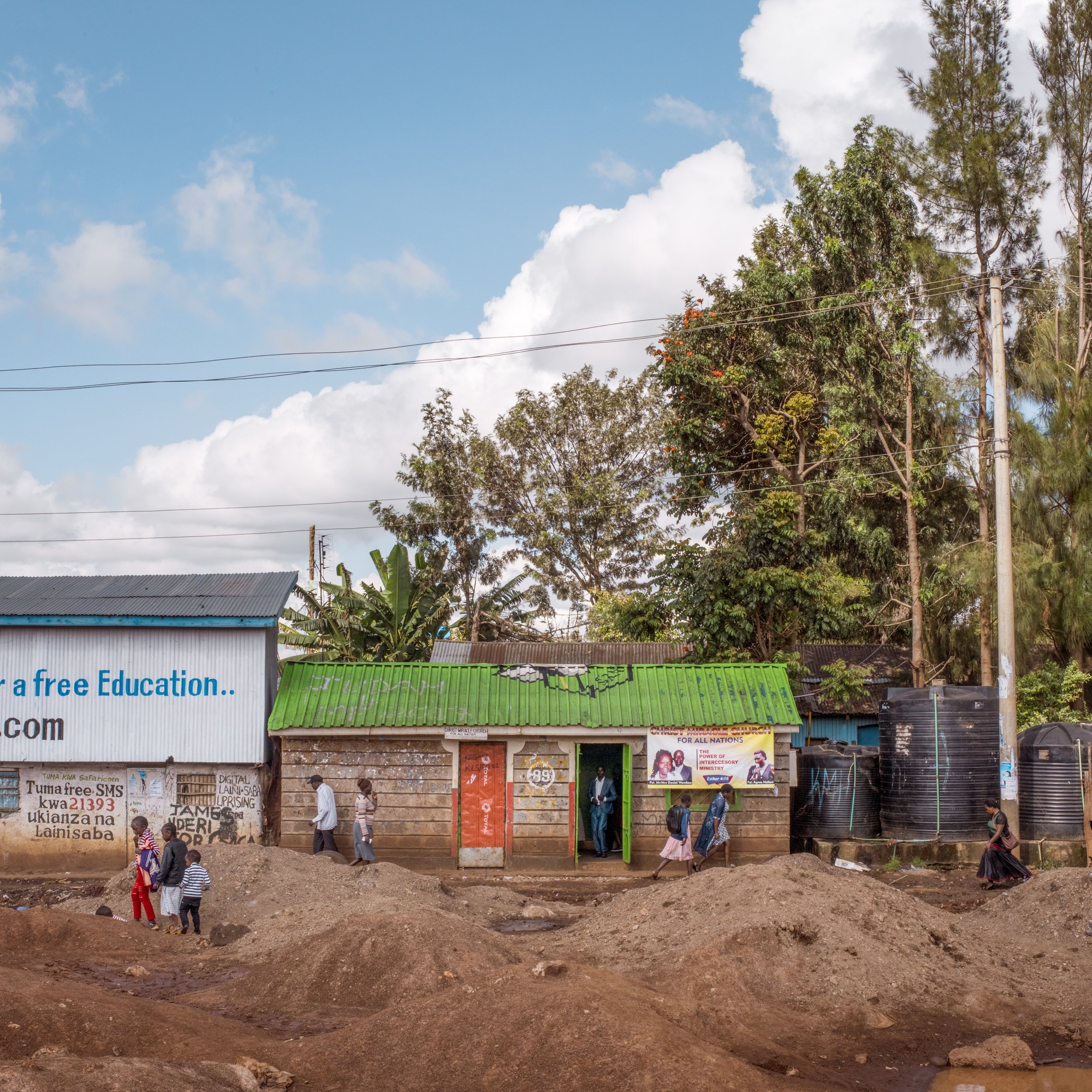  Christ Miracle Church, center, originally built as a public toilet facility. Kibera, Nairobi, Nairobi County, Kenya. Photographed May 13, 2018.  The building the church now occupies is one of the dozens of public toilet facilities built by the gover