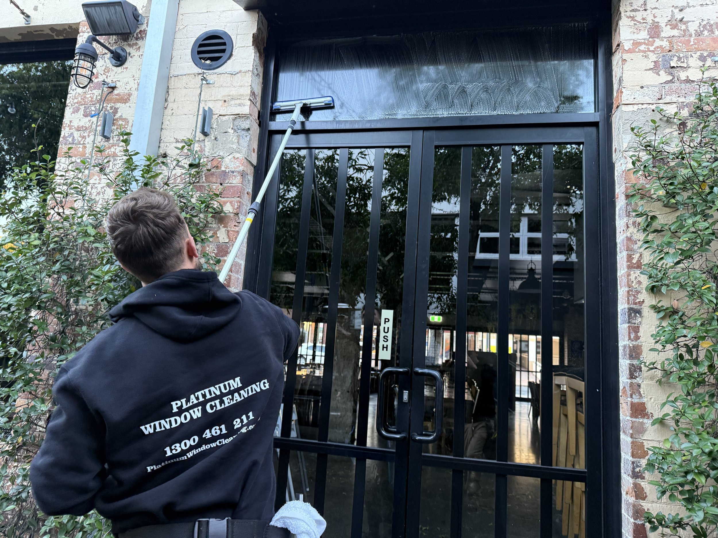 Cleaning the outside windows of a restaurant in Ipswich