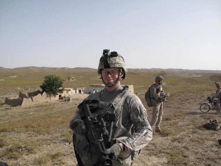 Nate Bethea, a member of the First Battalion, 501st Infantry, holding an M-4 carbine in Baghgay in Paktika province, Afghanistan, in 2009. Credit: Christopher Campbell