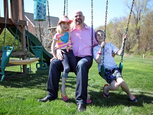 Eric Milgram sits with his two children, Dalton, 10, and Lauren, 7, at their Sandy Hook, Conn. home on May 4, 2013. Both children were at Sandy Hook Elementary School the day one of the deadliest school shootings in U.S. history took place. (Photo: Tania Savayan, The (Westchester County, N.Y.) Journal News)