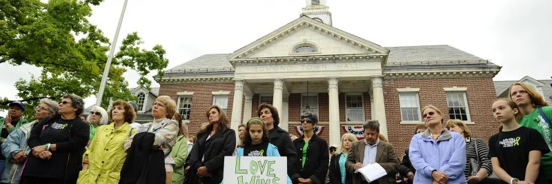 People gather during a ceremony on the six-month anniversary honoring the 20 children and six adults gunned down at Sandy Hook Elementary school on Dec. 14, 2012 at Edmond Town Hall in Newtown, Conn., Friday, June 14, 2013. Newtown held a moment of silence Friday for the victims of the massacre at Sandy Hook Elementary School at a remembrance event that doubled as a call to action on gun control, with the reading of names of thousands of victims of gun violence