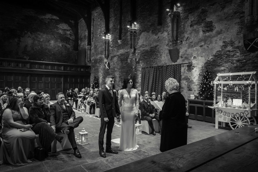 Black and white photograph of bride and groom at Caerphilly Castle wedding ceremony