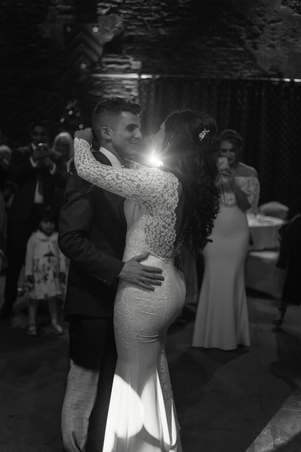 Black and white image of bride and grooms first dance