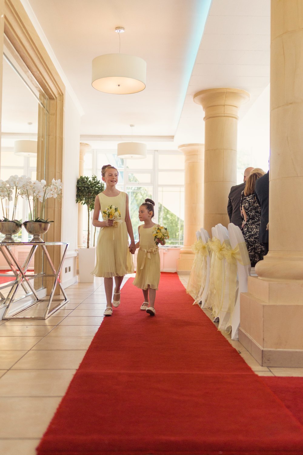 Two flower girls walking up the aisle at a Vale Resort Wedding Ceremony