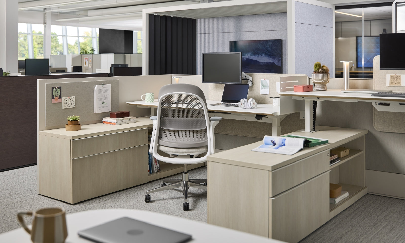 Modern office with a chair, upholstery cubicle walls, drawers, and surfaces for working