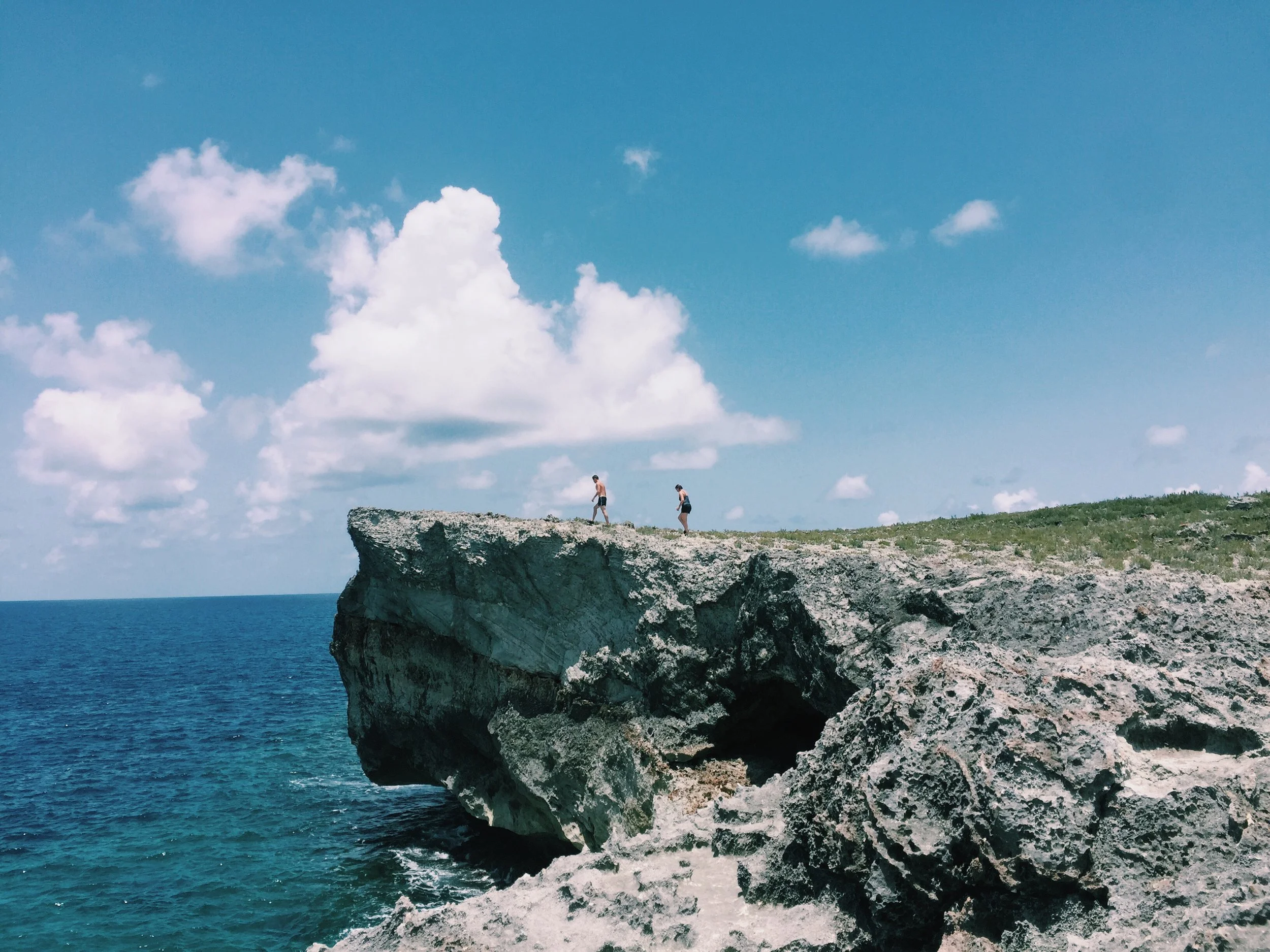  Eleuthera, Bahamas (July 2018)    A rotten wooden sign, its white coat of paint severely chipping from the tropical humid air, hung from a tree along Queens Highway. “The Cliffs” it read with an arrow pointing east, towards the deep blue Atlantic. W