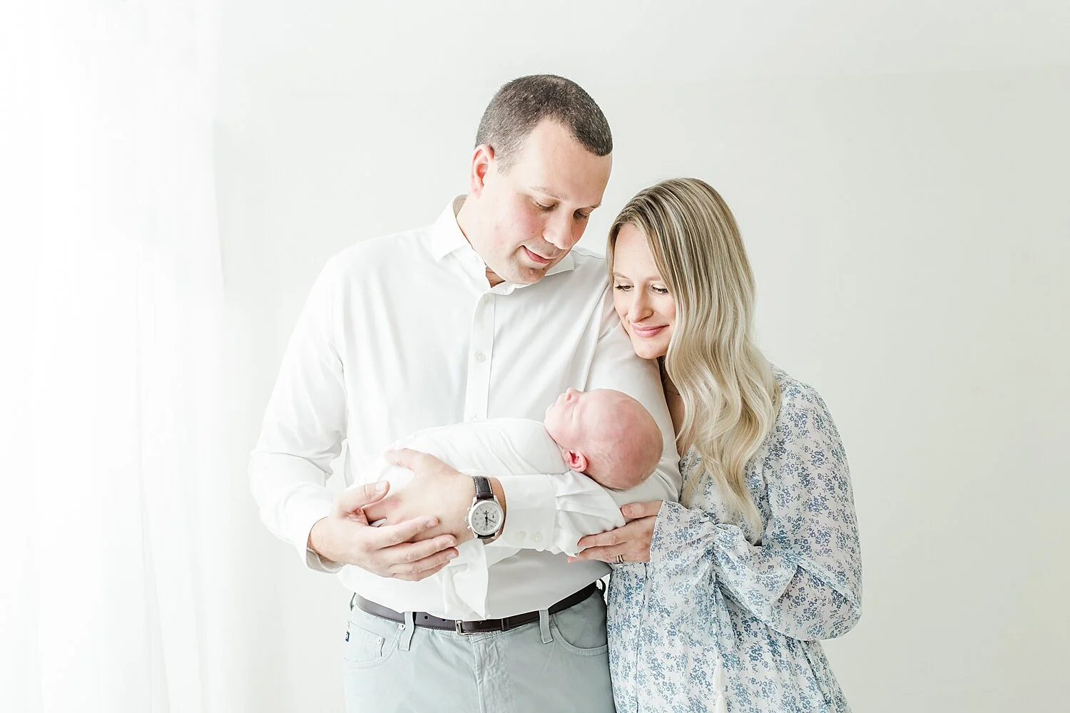 First-time parents holding their baby boy for photos with Kristin Wood Photography.