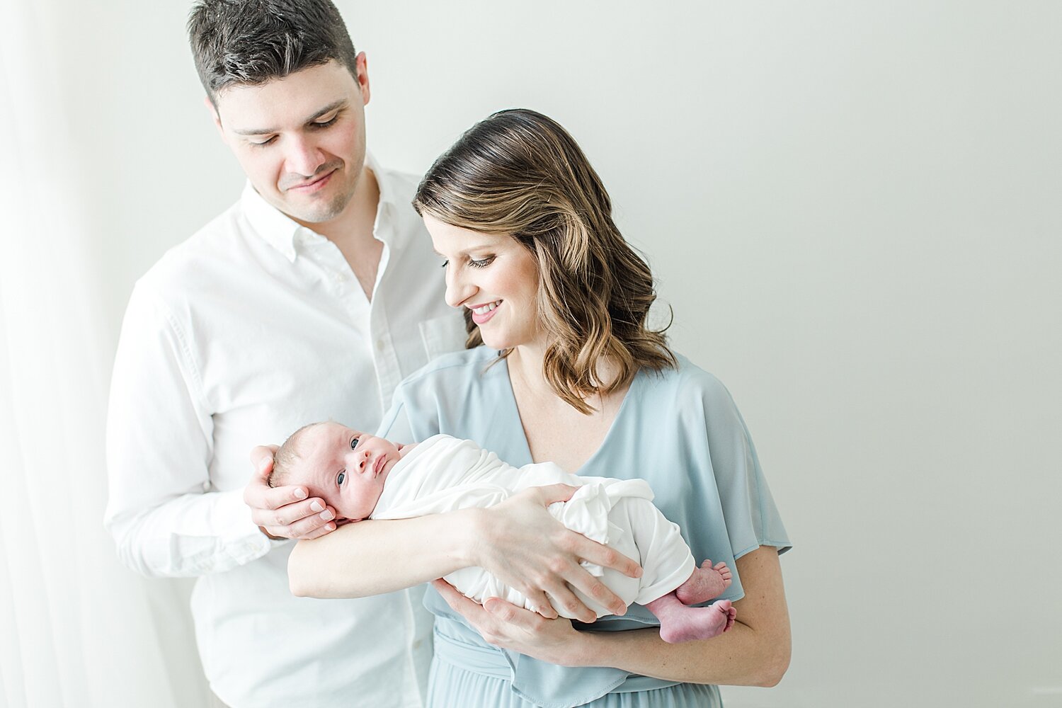 First time parents with baby boy. Photos by Kristin Wood Photography, a studio newborn baby photographer in Fairfield County, Connecticut.