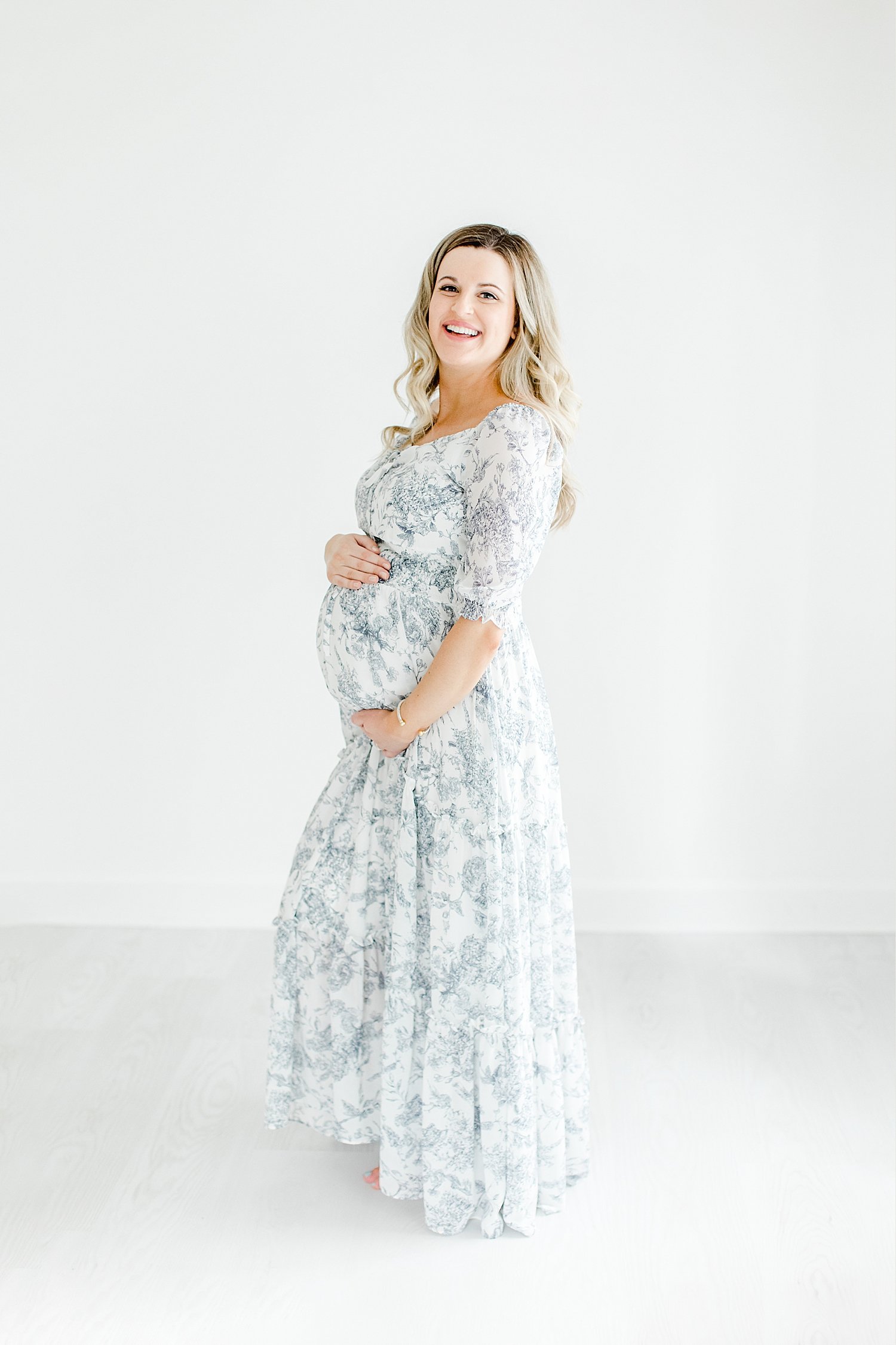Mom smiling during maternity session in the studio with Kristin Wood Photography.