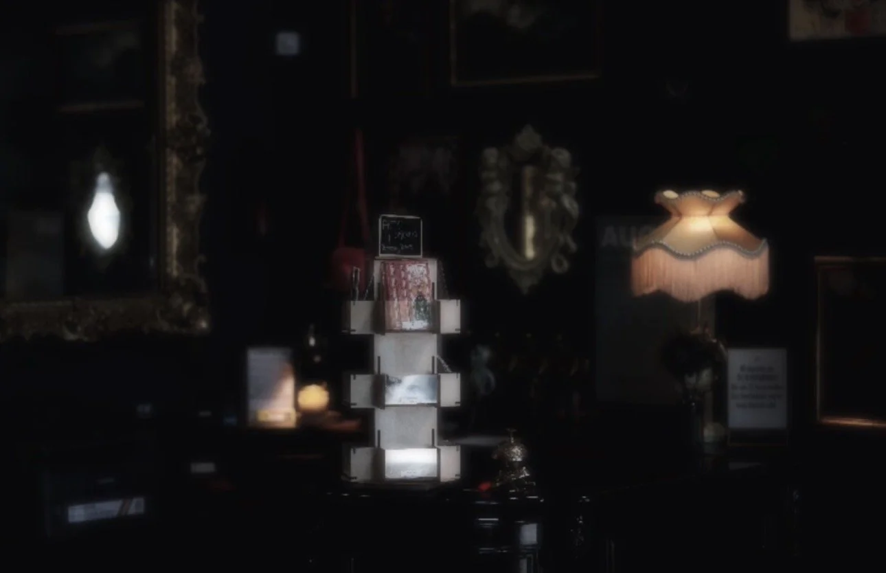 Dimly lit antique shop interior with mirrors, framed art, and vintage lamps, creating a cozy, nostalgic atmosphere.