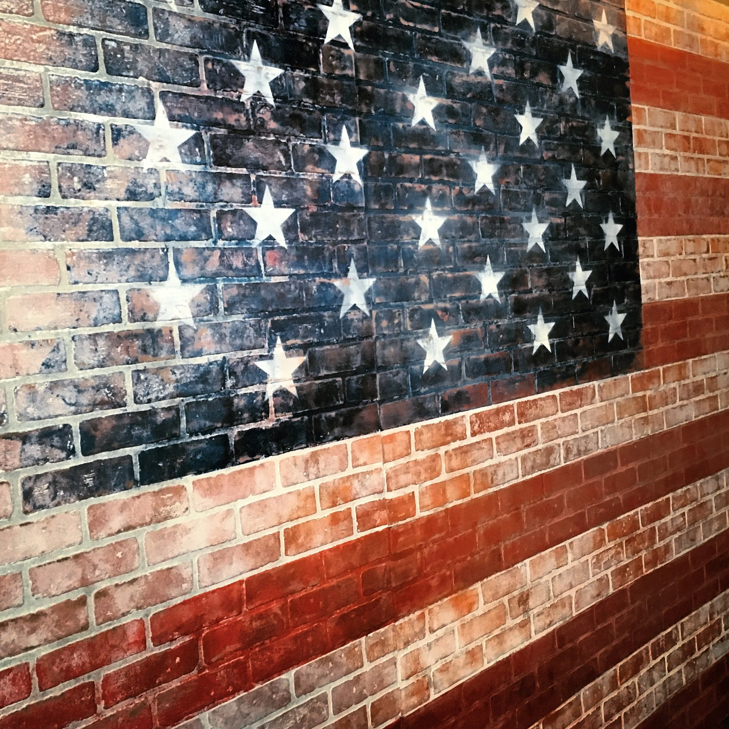  CHOPPED, FOOD NETWORK: DETAIL OF PAINTED FADED FLAG ON FAUX BRICK 