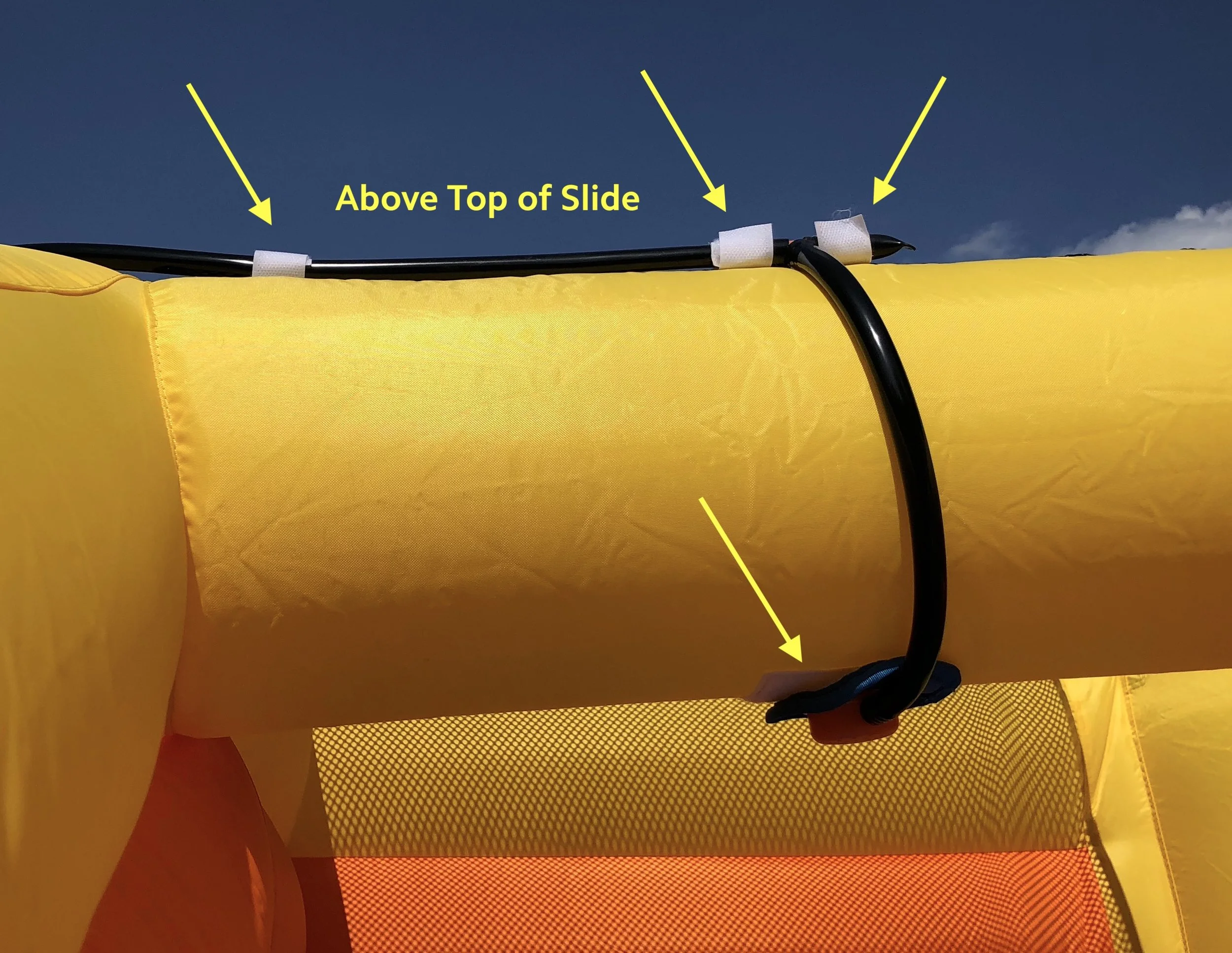8a. Attach the sprinkler above the top of the left slide using Velcro. Secure the hose using the additional Velcro straps.