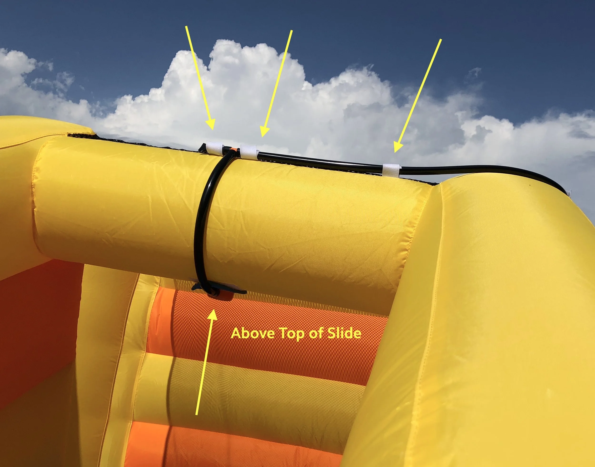 8d. Continue attaching hose around the front of the right slide. Attach the sprinkler above the top of the right slide using Velcro. 8e. Attach garden hose and gently turn on water (1/2 turn should work). EXCESS WATER PRESSURE CAN DAMAGE HOSES AND CONNECTORS.
