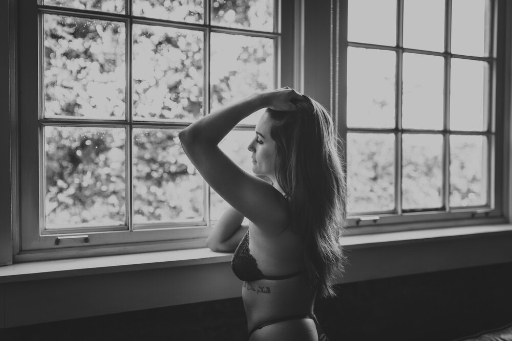 Oklahoma City Dallas boudoir photographer black and white portrait of woman standing in front fo window