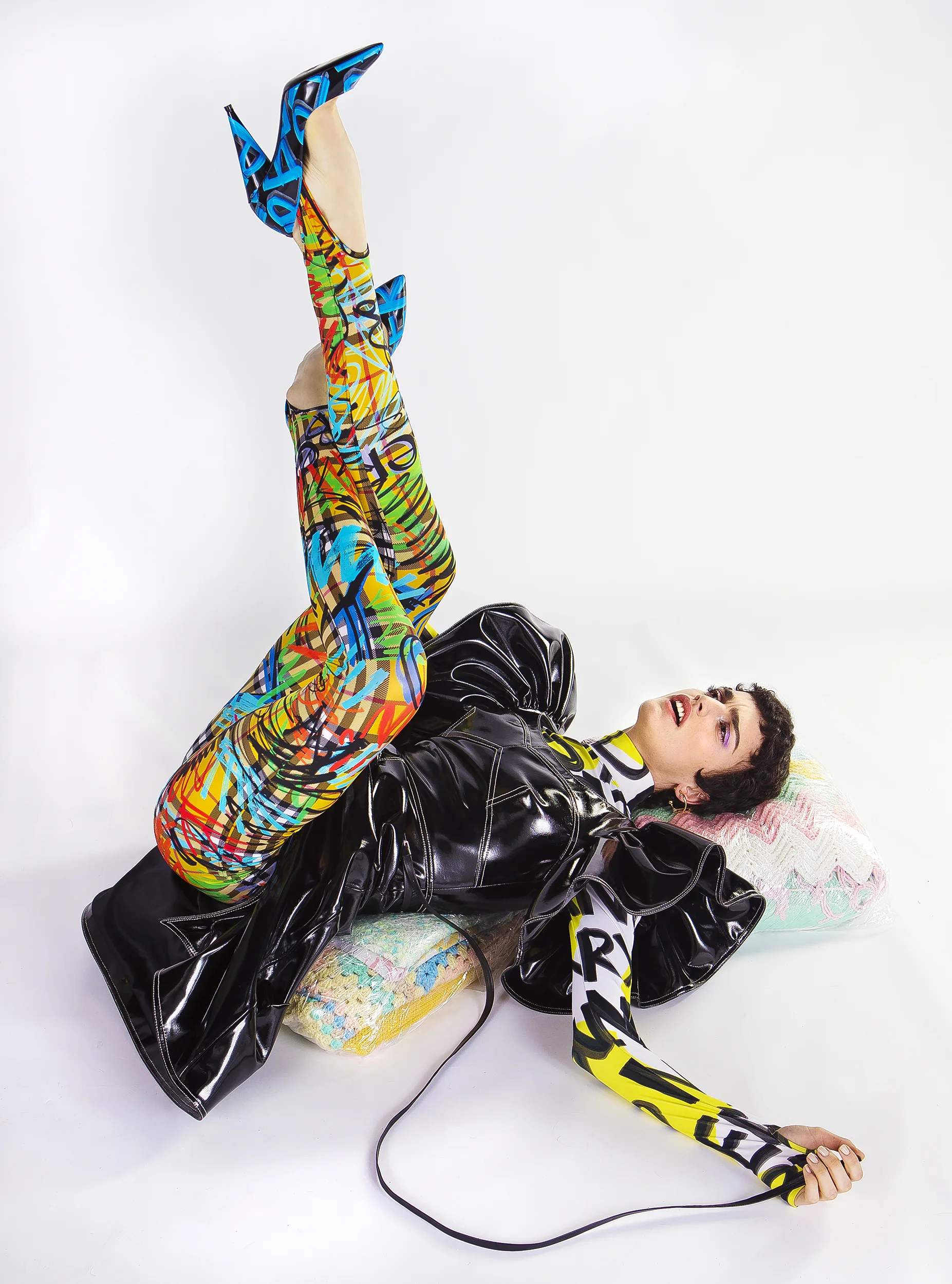 Black patent leather dress - CHRISTIAN SIRIANO Gold earrings - BURBERRY Yellow graffiti print turtleneck bodysuit - BURBERRY Belt - MARC JACOBS Graffiti leggings - BURBERRY Shoes - BURBERRY