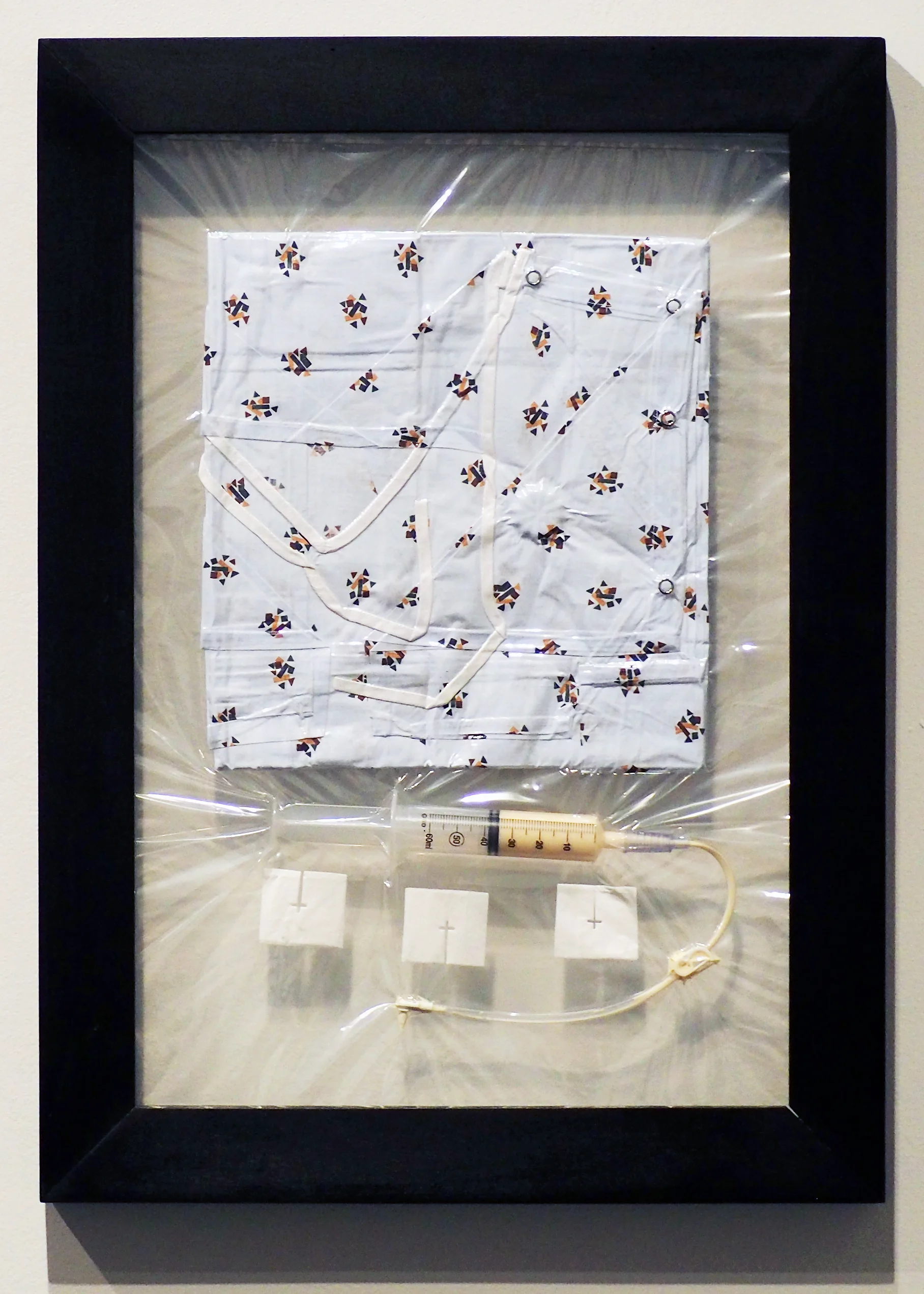 Relics Vacuum 2. Hospital Gown, gastronomy feeding tube, and gauze sealed inside plastic bag. 2017.