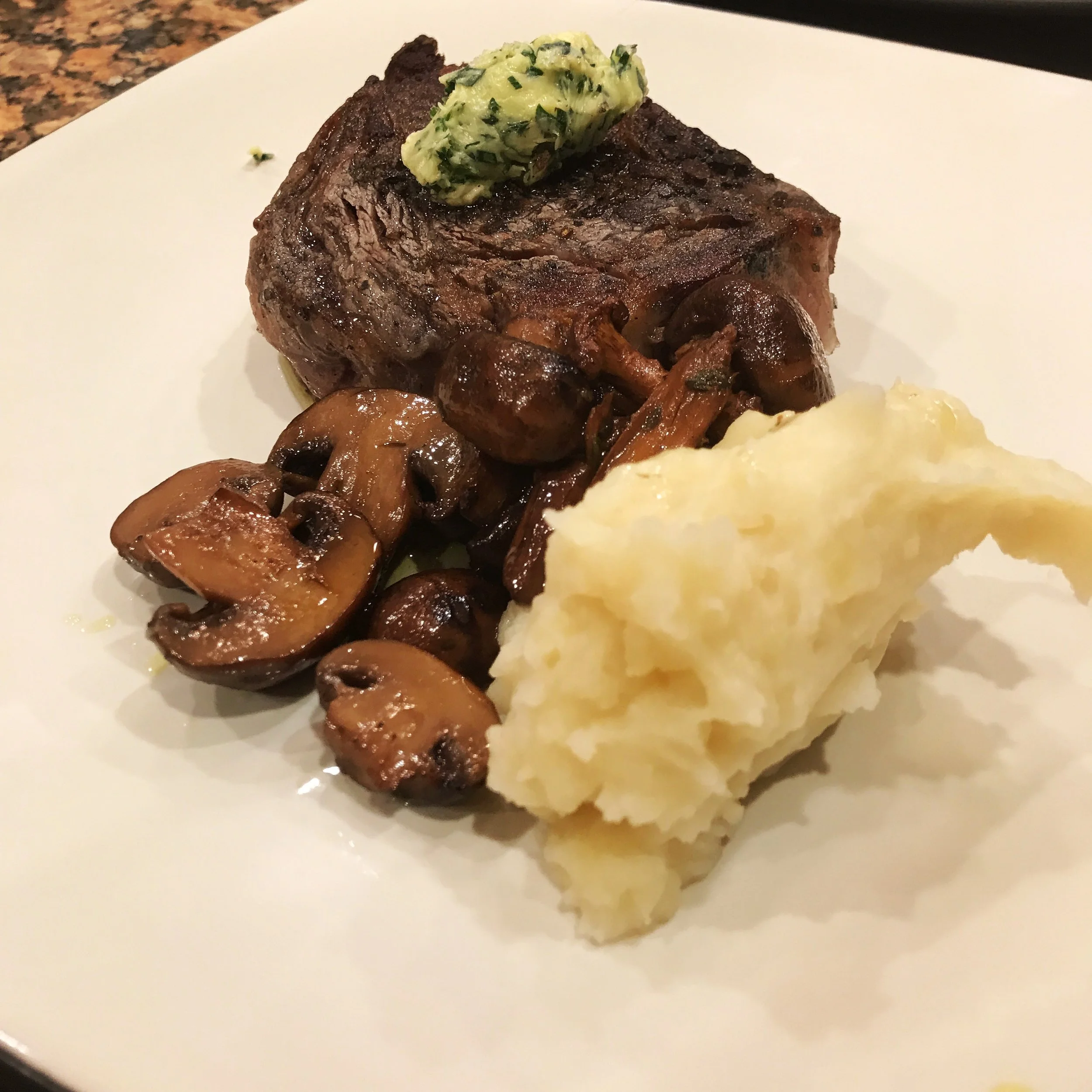 black lava salt-crusted steak, roasted garlic mashed potatoes, wild mushroom confit 