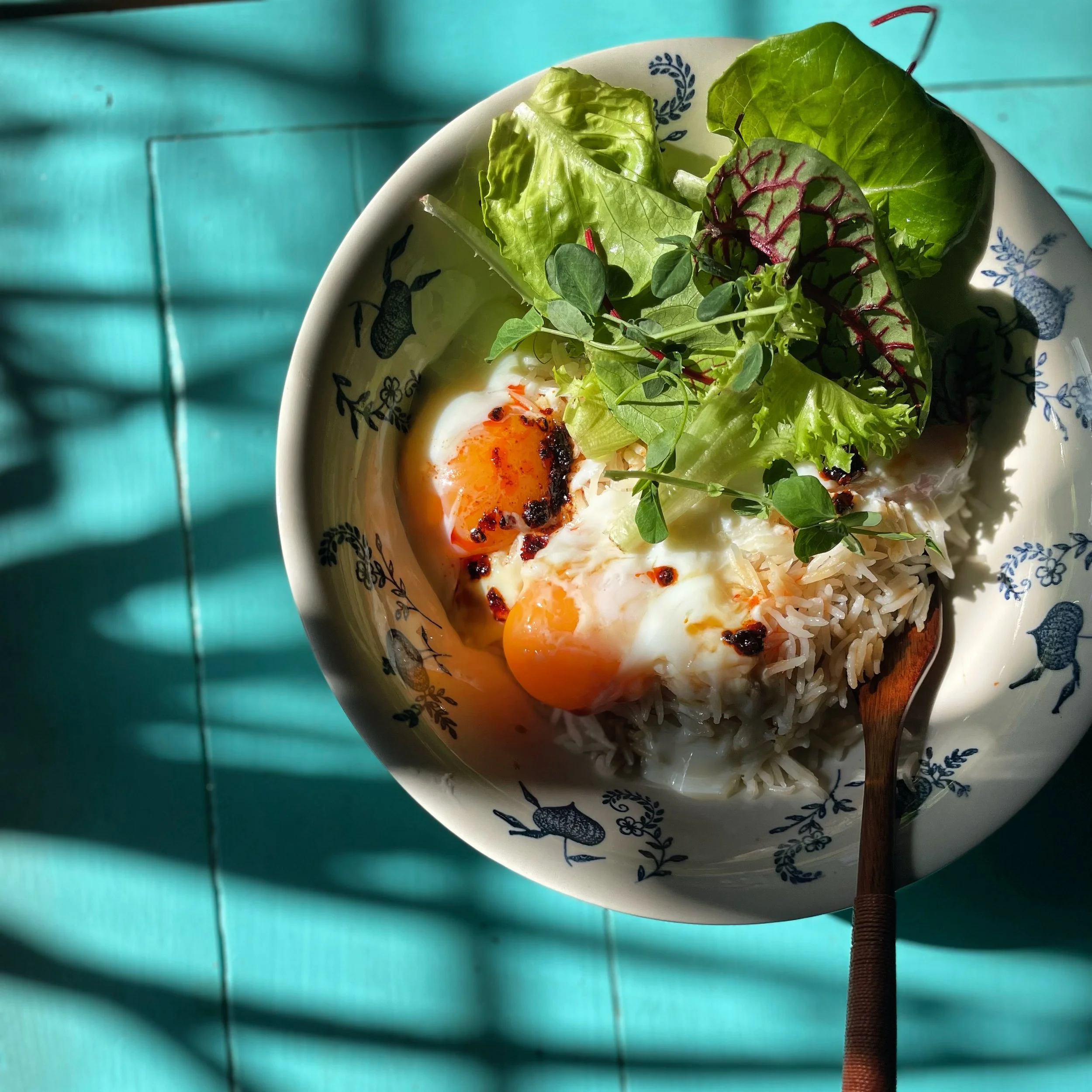  Onsen egg over rice and greens with chili pepper oil 