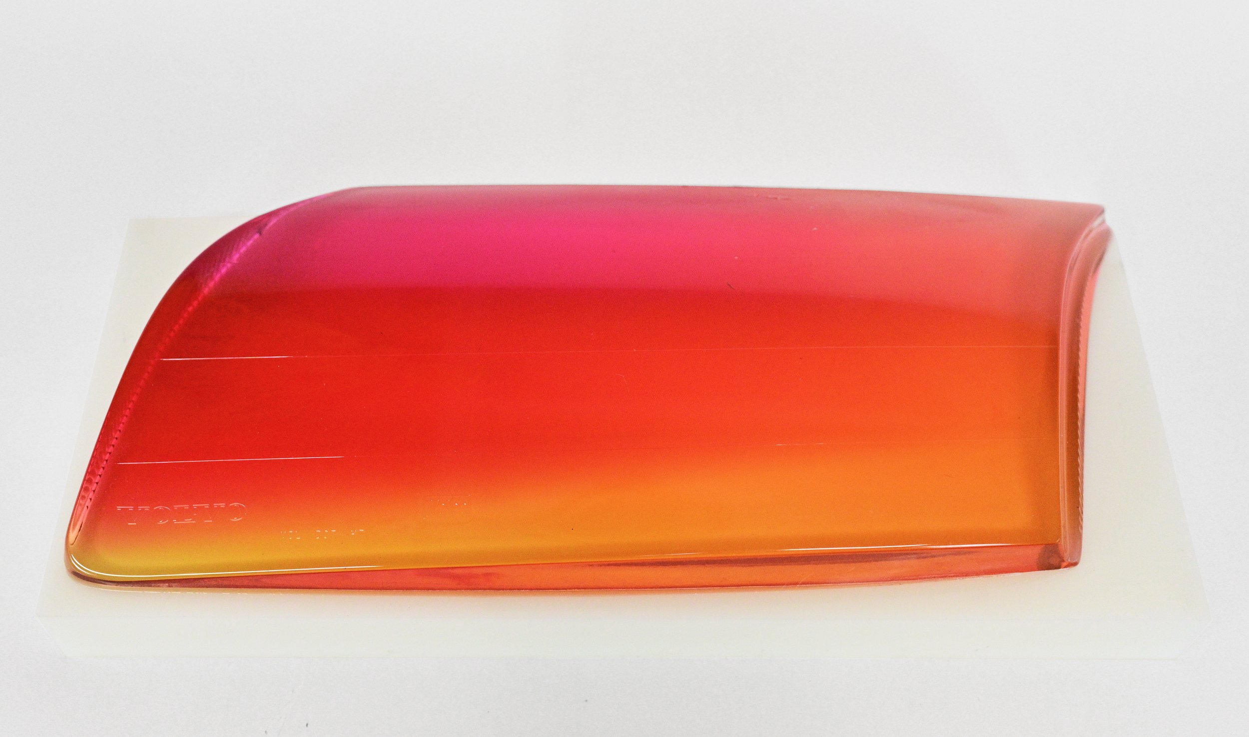   R.O.M., (Red, Orange, Magenta)  Found (1999 Volvo) tempered glass headlight lens, resin, 16 ½”L x 7 1/8”W x 3”H  