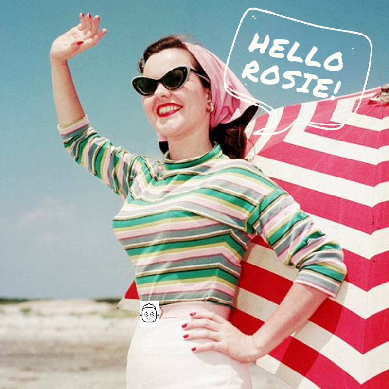 A woman on the beach wearing sunglasses, a striped shirt, and a pink headscarf, smiling and waving, with a red and white striped beach umbrella in the background. A speech bubble says, "HELLO ROSIE!"