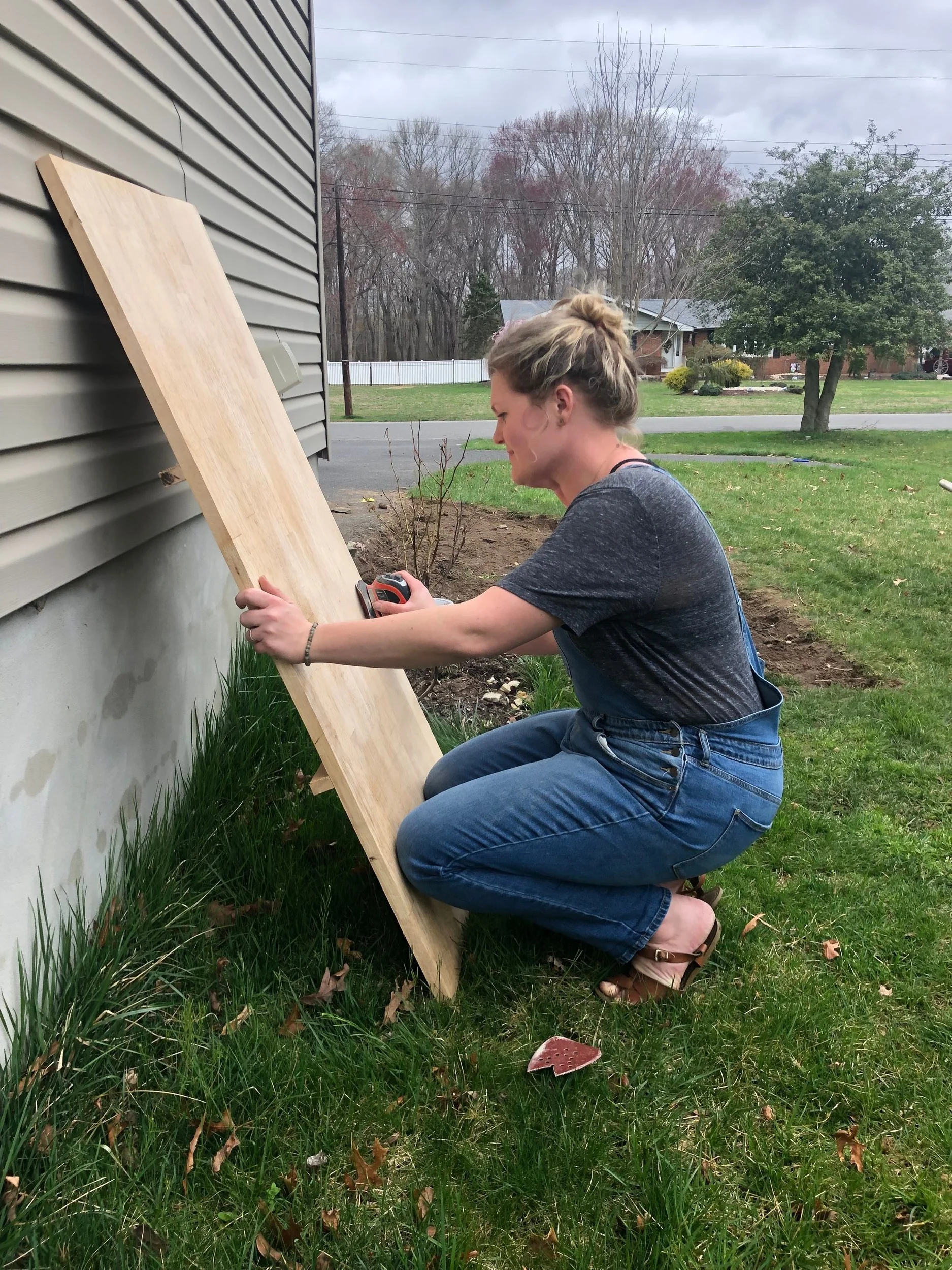 Sanding down the table with a palm sander.