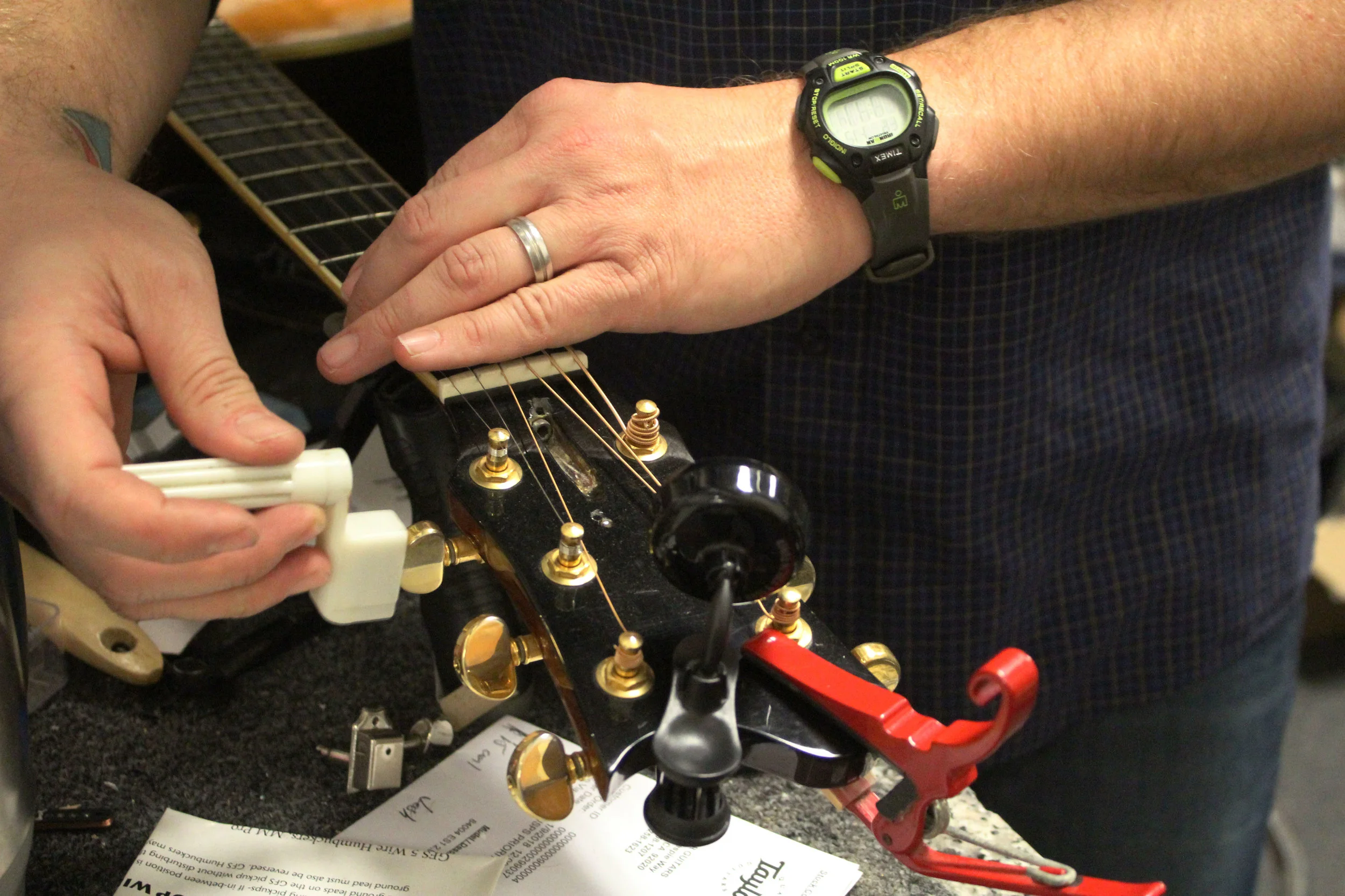 Brent Moore tightens strings on Friday, Jan. 19, 2018 at CoMo Guitar Works in Columbia, Mo. “It’s really difficult to be sitting, looking at a computer all day or do something like that,” Moore said. “It’s much more enjoyable to work with my hands, to be creative, to be able to use that part of my brain. But I also get to have it be my job, it is really cool.”