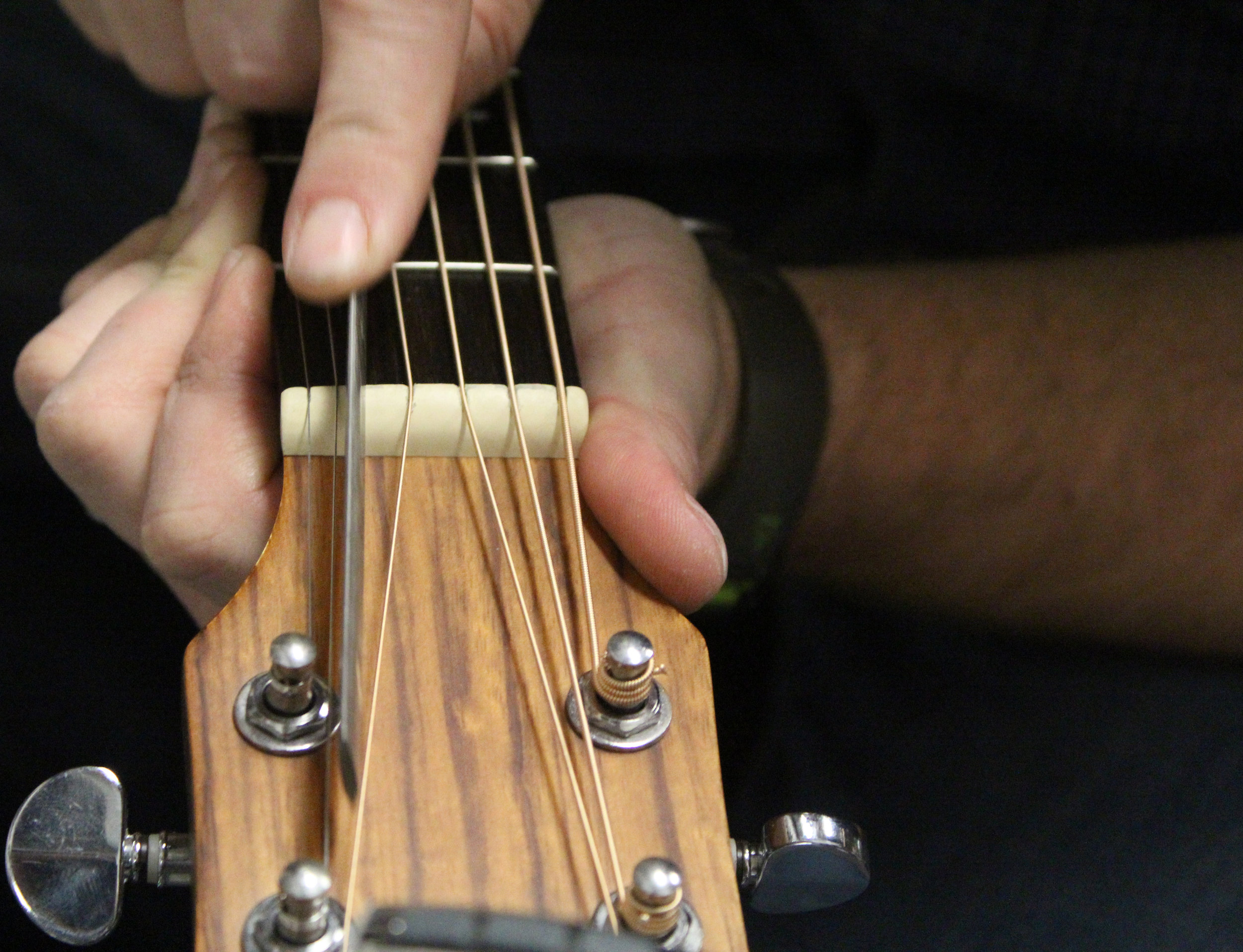 Brent Moore files the guitar nut on Friday, Jan. 19, 2018, at CoMo Guitar Works in Columbia, Mo. “We’ve come down here to ask him some questions about pickups and stuff,” Olivia Burney said. “He’s been really, really helpful.”