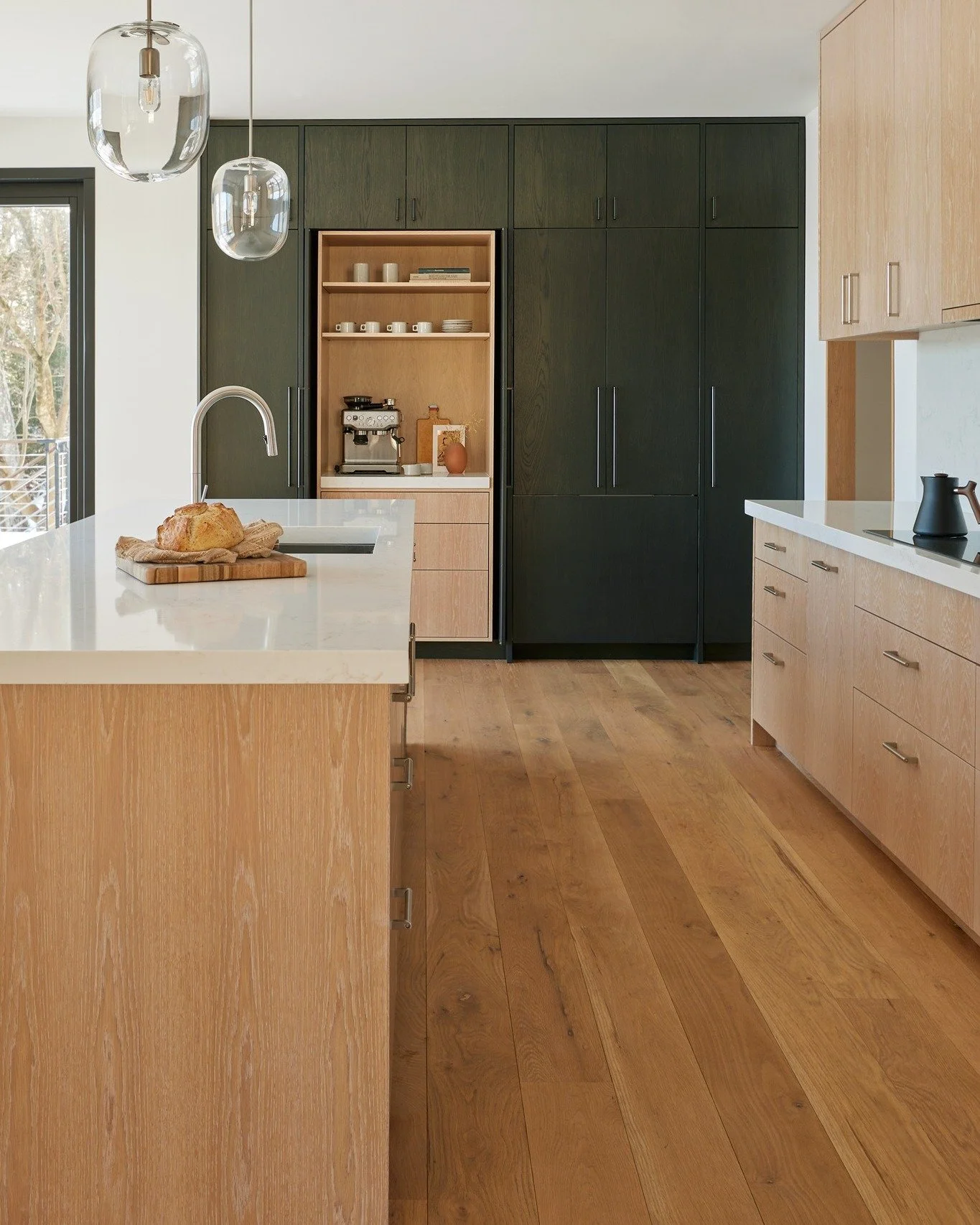Inside China Pond Passive: natural materials, carefully framed views, and a restrained palette shape the everyday spaces of the home, from the kitchen at its center to the cedar-lined sauna tucked within.

Throughout China Pond, comfort and performan