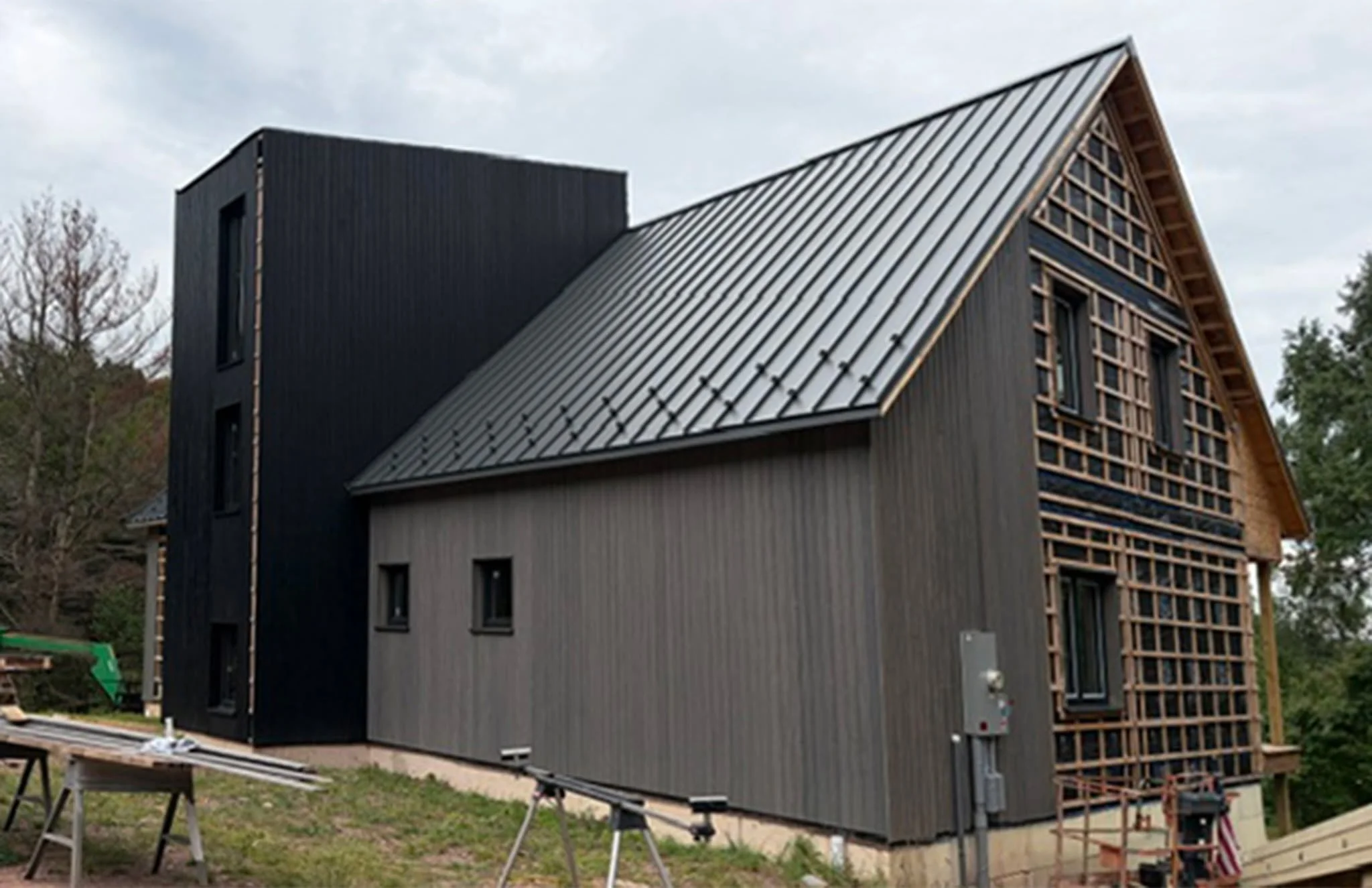 A snapshot from the site in Damascus, PA: with exterior cladding underway, the relationship between the home&rsquo;s simple gabled forms and taller central volume is coming into focus. At the top, an observation room creates a perch for taking in the