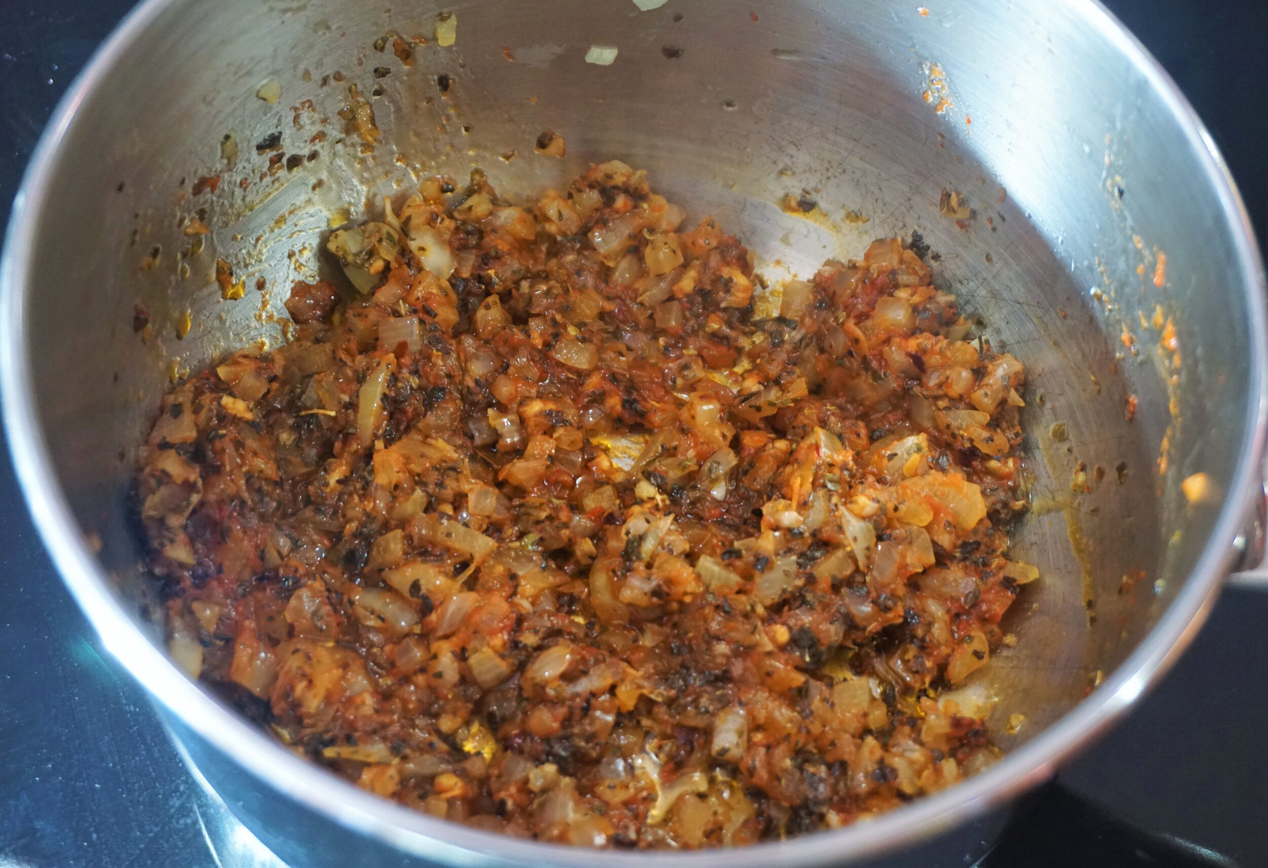 Fry the tomato paste for a minute or so.